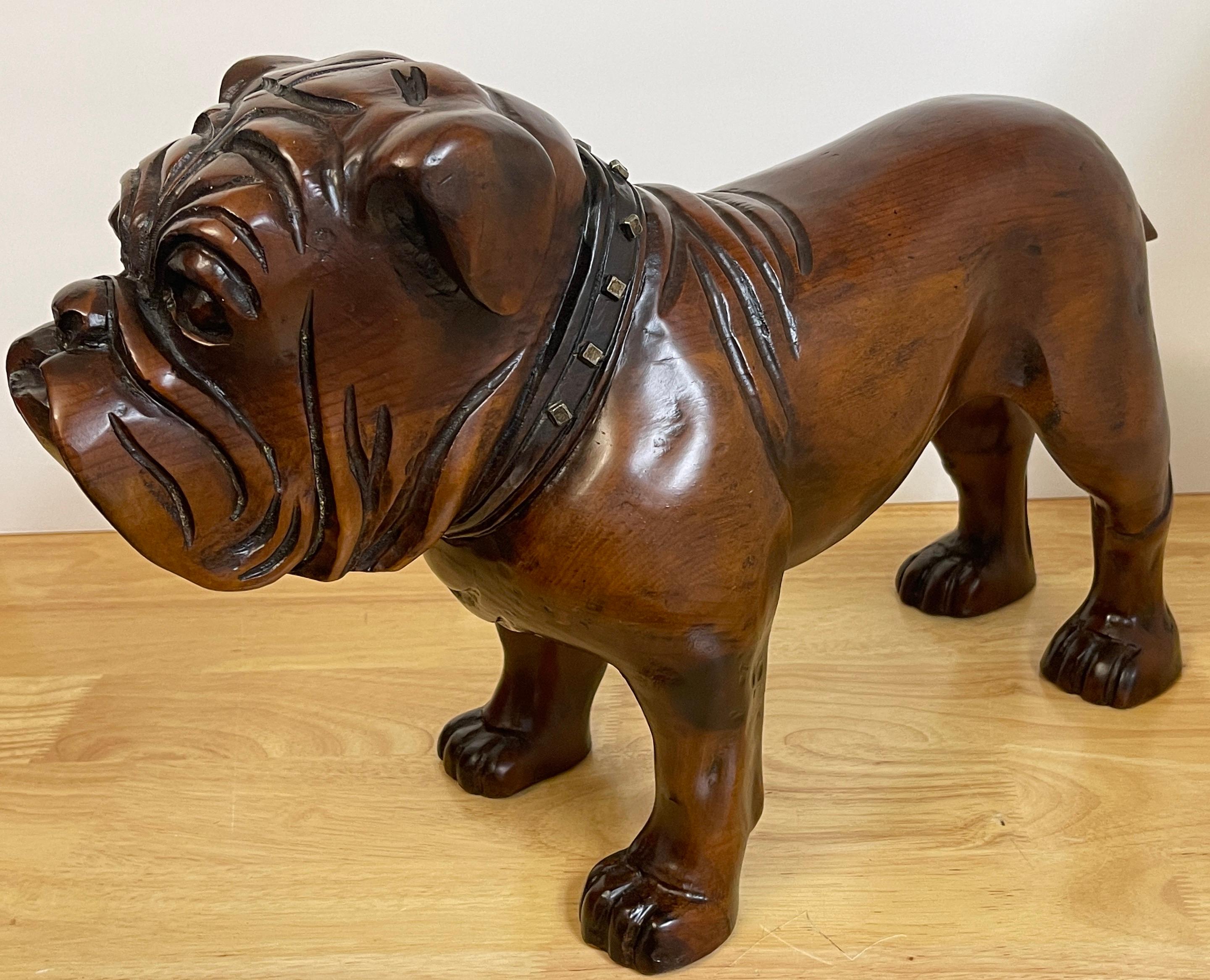 Antique English Carved Hardwood Bull Dog with Cut Steel Collar 
England Early 20th Century 
Observe exquisite craftsmanship of the Victorian era with this exceptional antique English carved hardwood Bull Dog. This lifelike and well carved masterwork
