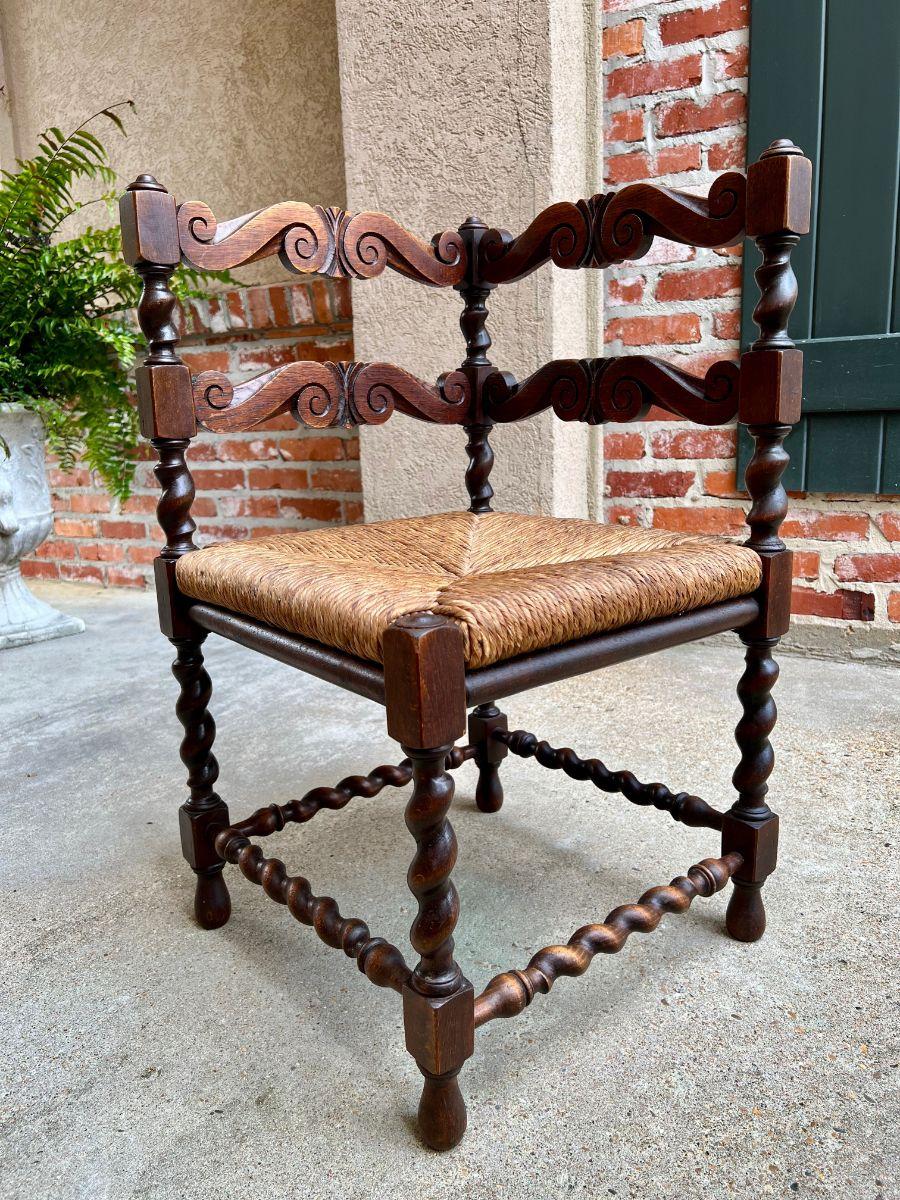 Antique English carved oak barley twist corner chair rush seat, c1900

Direct from England, with classic British style, this lovely antique English carved oak corner chair. Scalloped and carved ladder back with barley twist posts. Turned barley