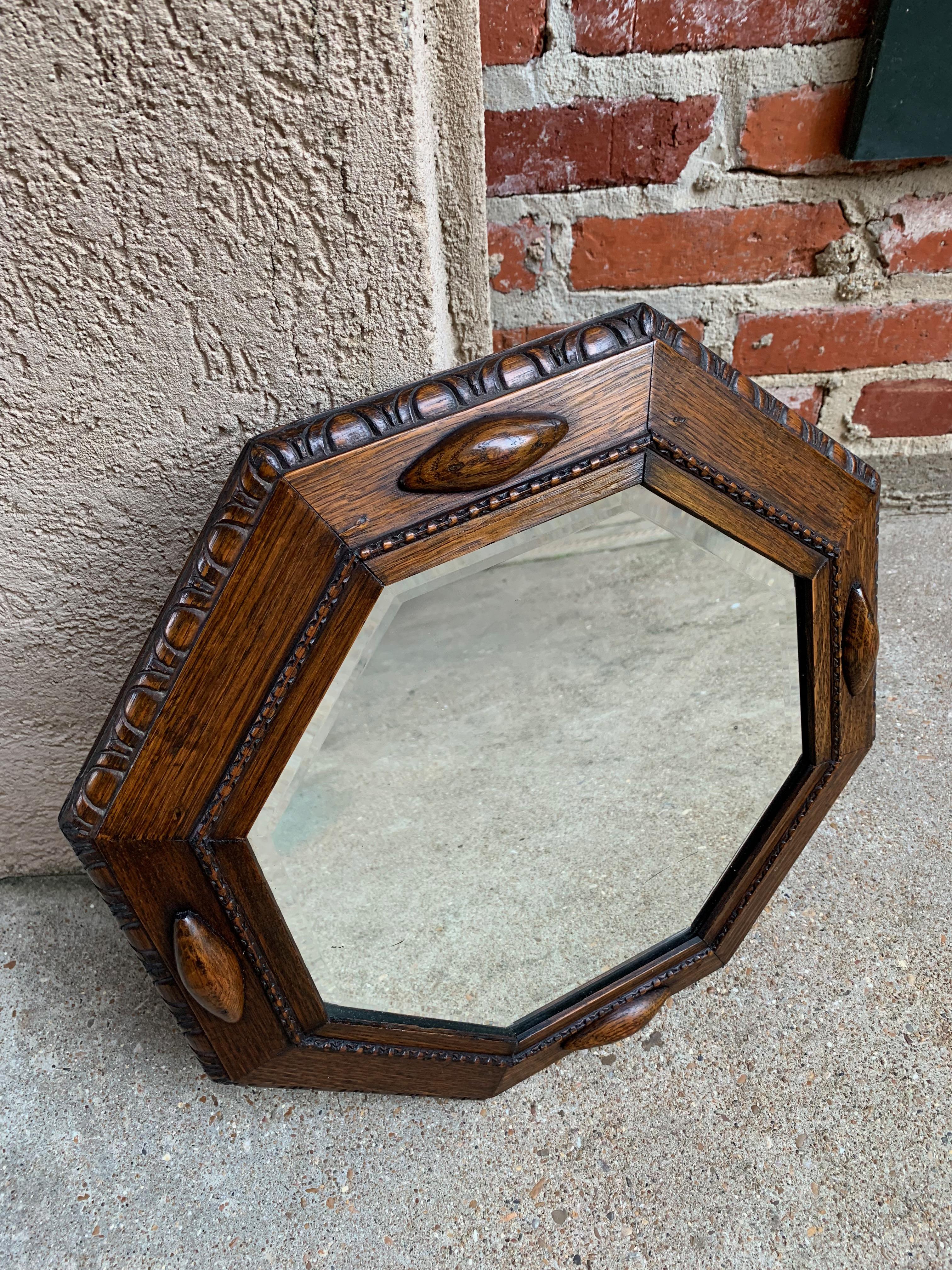 Direct from England, a lovely antique English oak frame wall mirror with a great octagon shape. Large carved beveled outer edge with raised carved trim detail inside and huge geometric applied trim on the compass points!
~ Wood frame is a somewhat