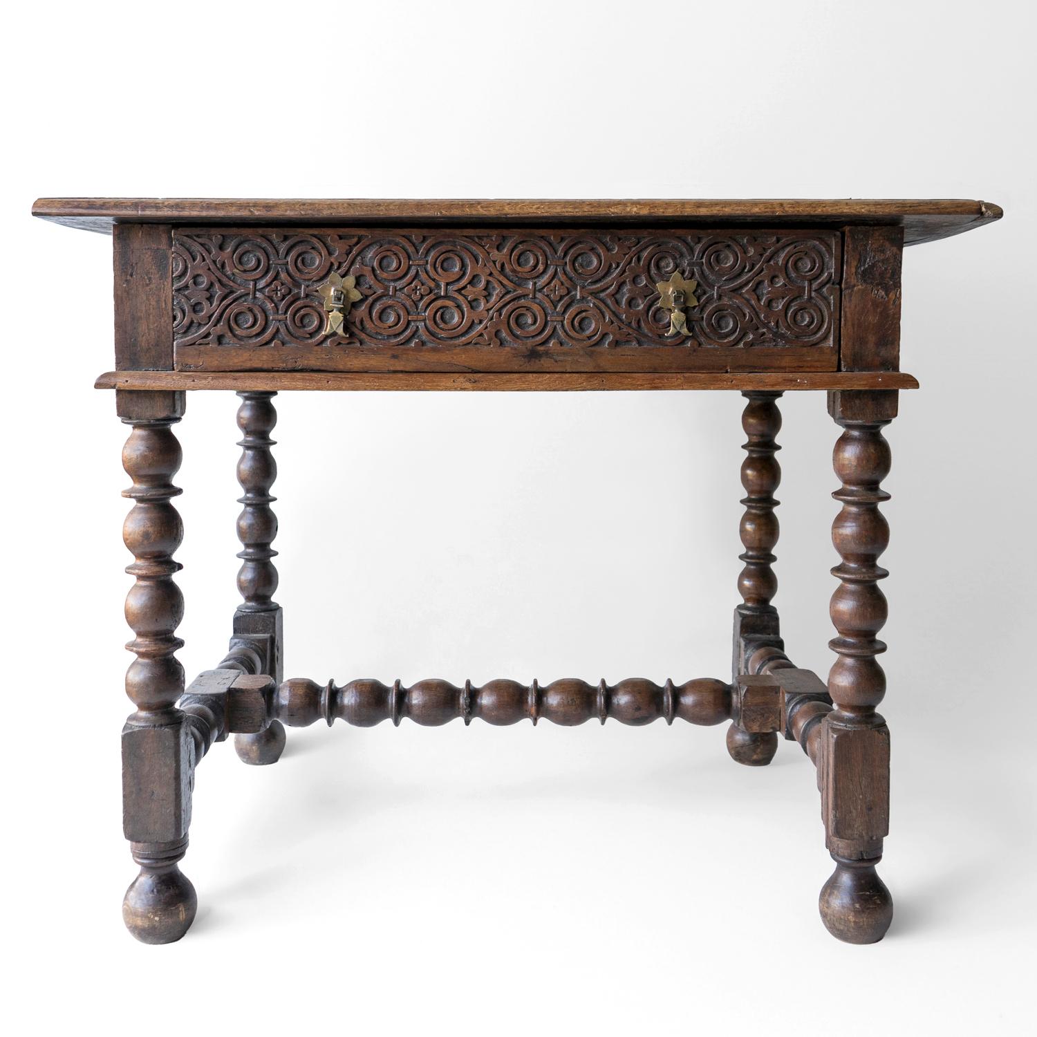 ANTIQUE RUSTIC COUNTRY MADE TABLE 
Peg joined and made from oak with a carved drawer and raised on bobbin-turned supports and stretchers. The panel on the right-hand side is also carved.

Probably dating from the mid-18th century circa 1750, made