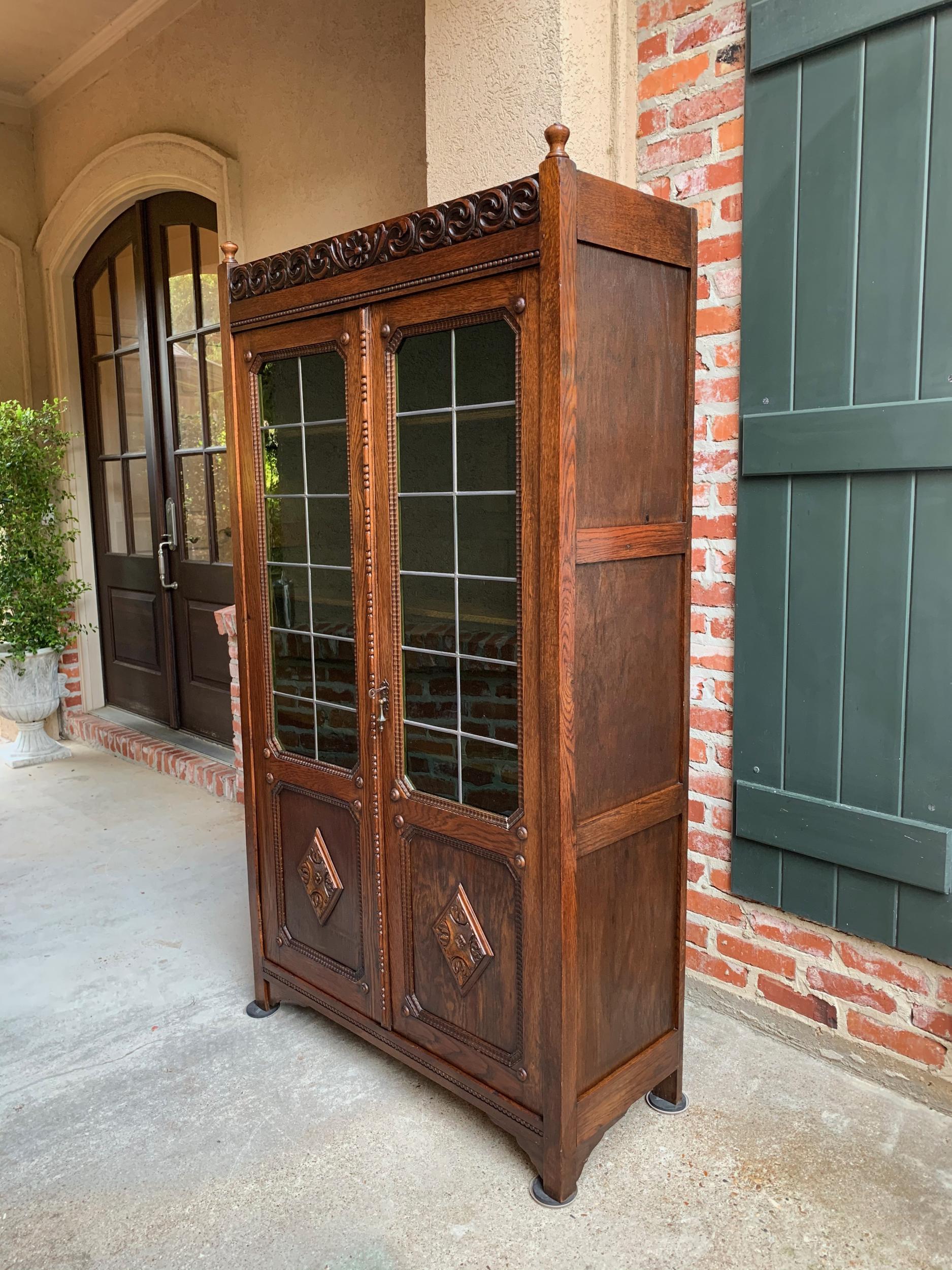 ~6 ft. tall antique English oak bookcase, with traditional English style and a slender profile to fit in so many areas of your home!~
~Full length carved crown flanked by oak finials above the large double doors~
~Jacobean style, loaded with