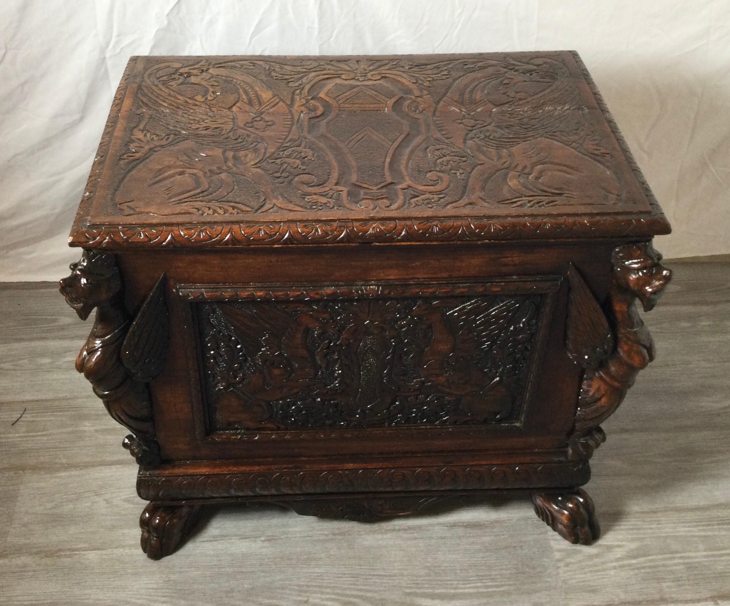 Antique English carved oak Cellarette with gargoyles and original tin insert. Refinished. Measures: 27