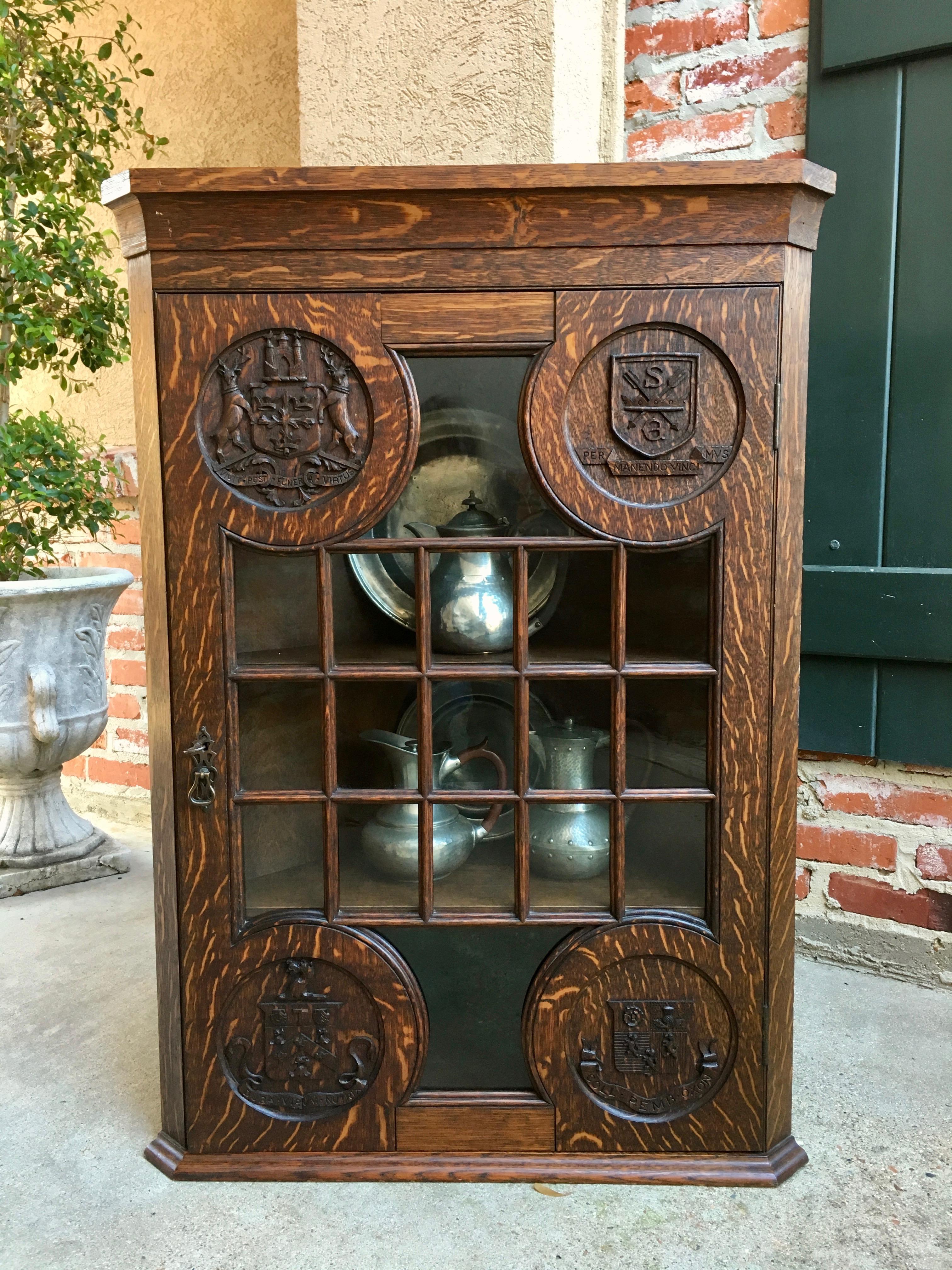Direct from England, a very unique antique English carved tiger oak corner wall cabinet ~
~Some of the most unique and amazing carvings. Each of the four is a different coat of arms, complete with their unique Latin motto~
Sedberg School in North