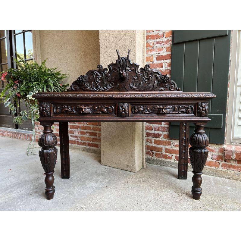 Antique English Carved Oak Hunt console hall table stag deer lion sofa table.
 
Direct from London, England, an elaborately carved console or hall table!
Large carved crown with carved floral and foliate designs, having a dimensionally carved