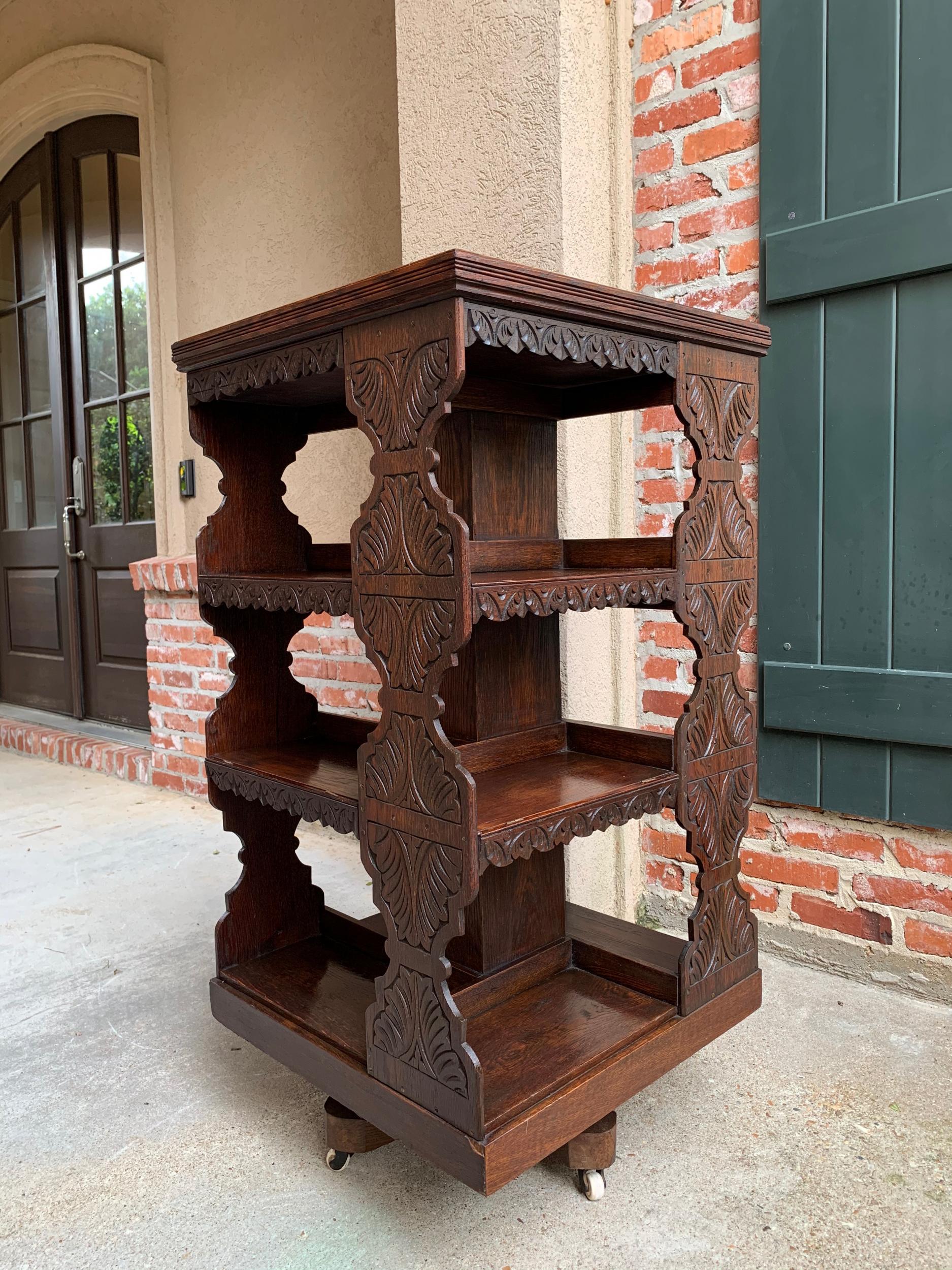 ~Direct from England~
Classic British style in this antique English oak revolving bookcase that both rolls and revolves. Distinctive, large, shaped edge, hand carved panels on each of the four sides. Note that each level also has carved edge trim