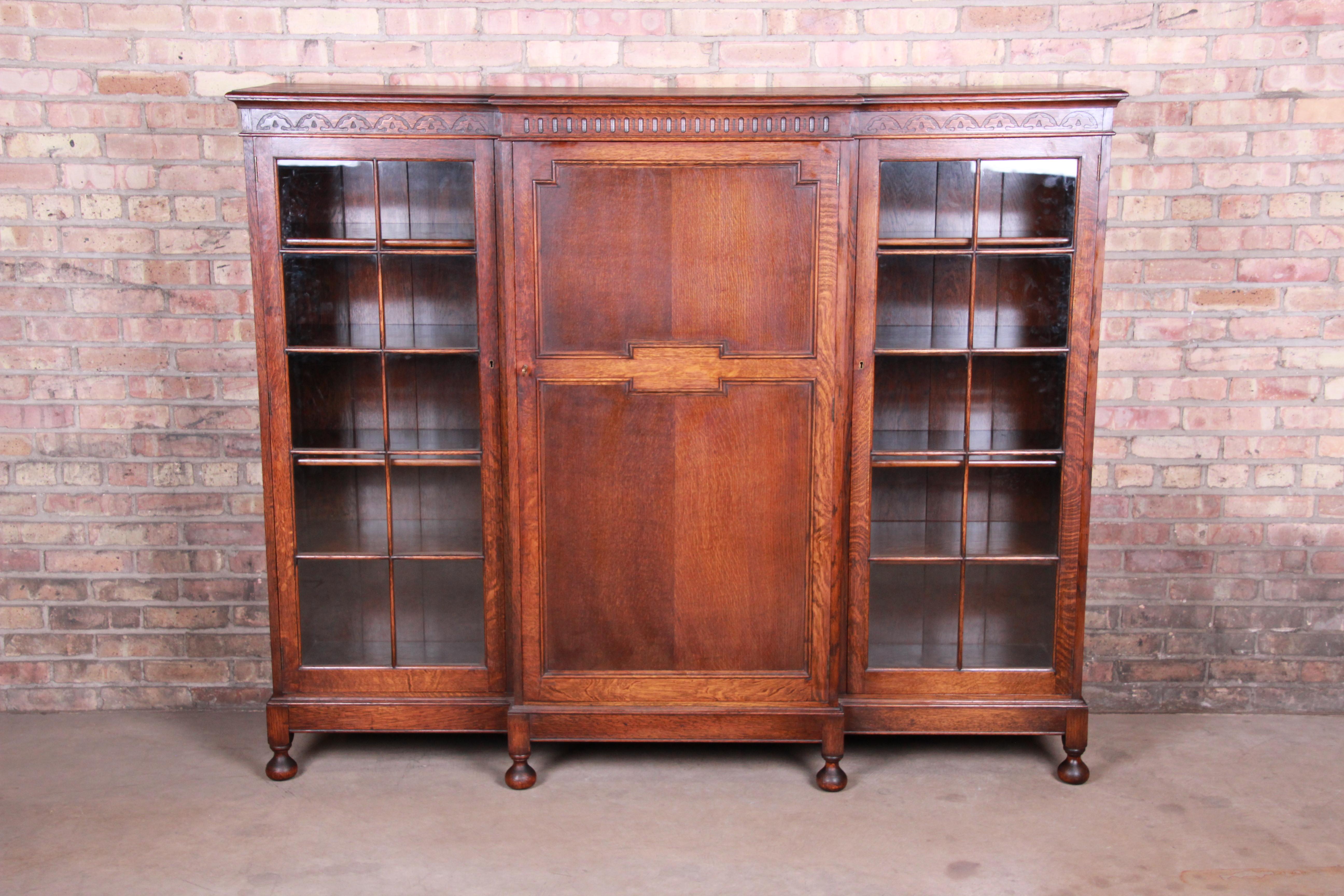 An exceptional antique carved oak triple bookcase

England, circa 1900

Solid oak with glass front doors.

Measures: 71