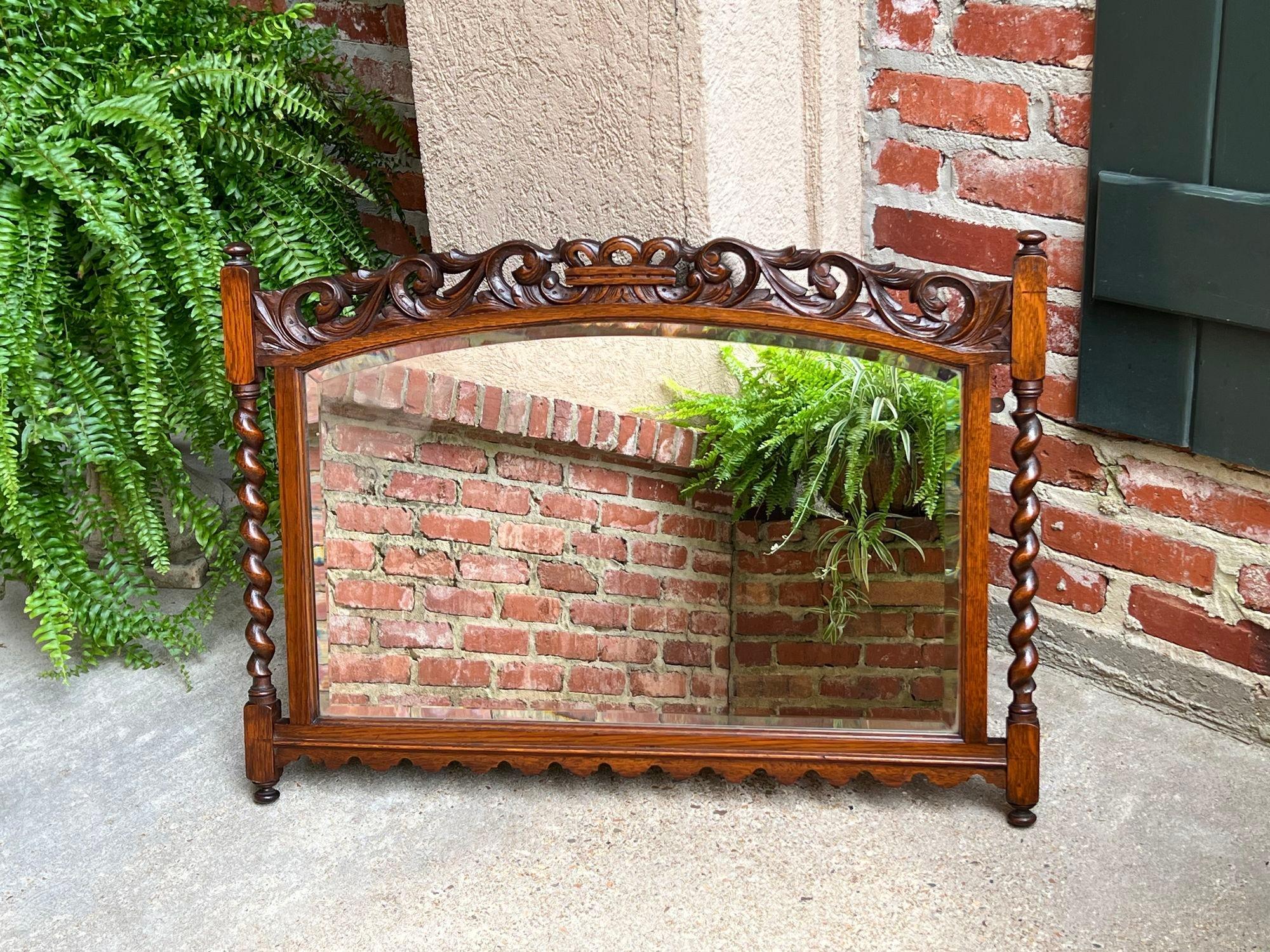 Antique English Carved Oak Wall Mirror Barley Twist Arched Top Frame Jacobean.

Direct from England, another fabulous antique English wall mirror! Elegant arched top features a wide, open carved band with carved center crown.
Barley twist posts to