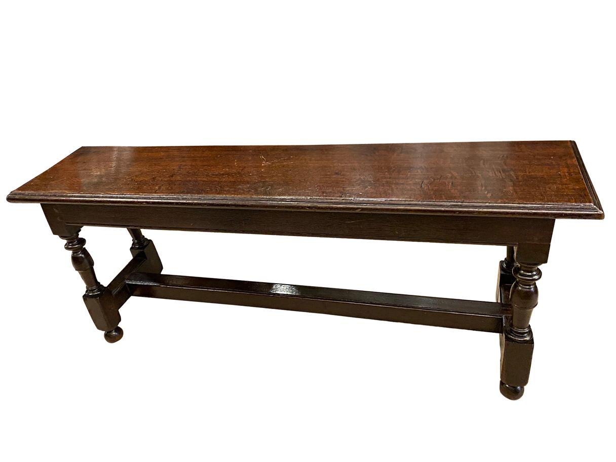 A circa 1900 English carved oak bench with original patina.

Measurements:
Height: 20