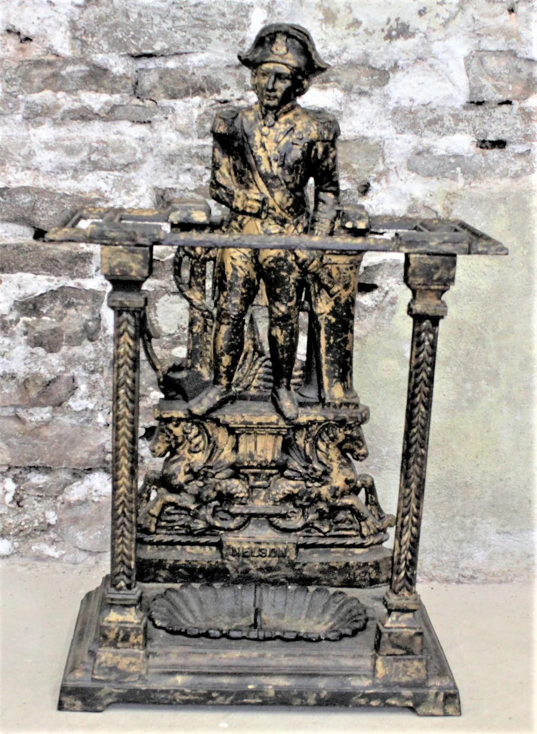 This antique cast iron umbrella or walking stick stand is unsigned, but presumed to have been made in England in circa 1880 in the period Victorian style. The ornate casting of this umbrella stand features a figural representation of Admiral Lord