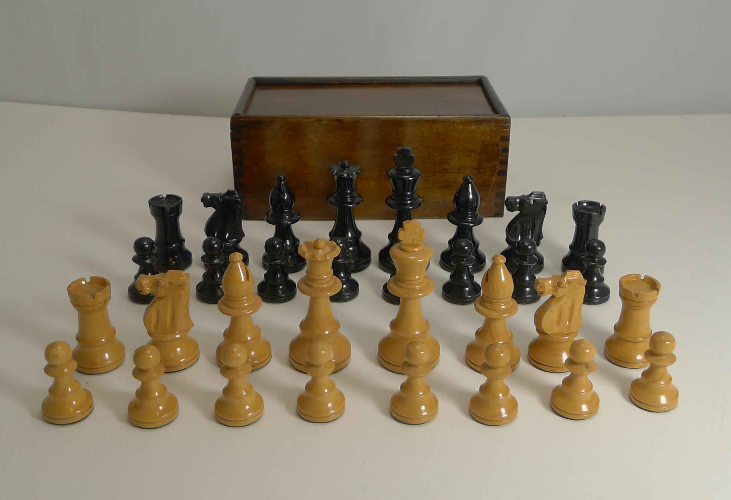 A very smart antique mahogany chess board paired with a boxwood Staunton style chess set inside a wooden storage box.

The board measures 13 1/4