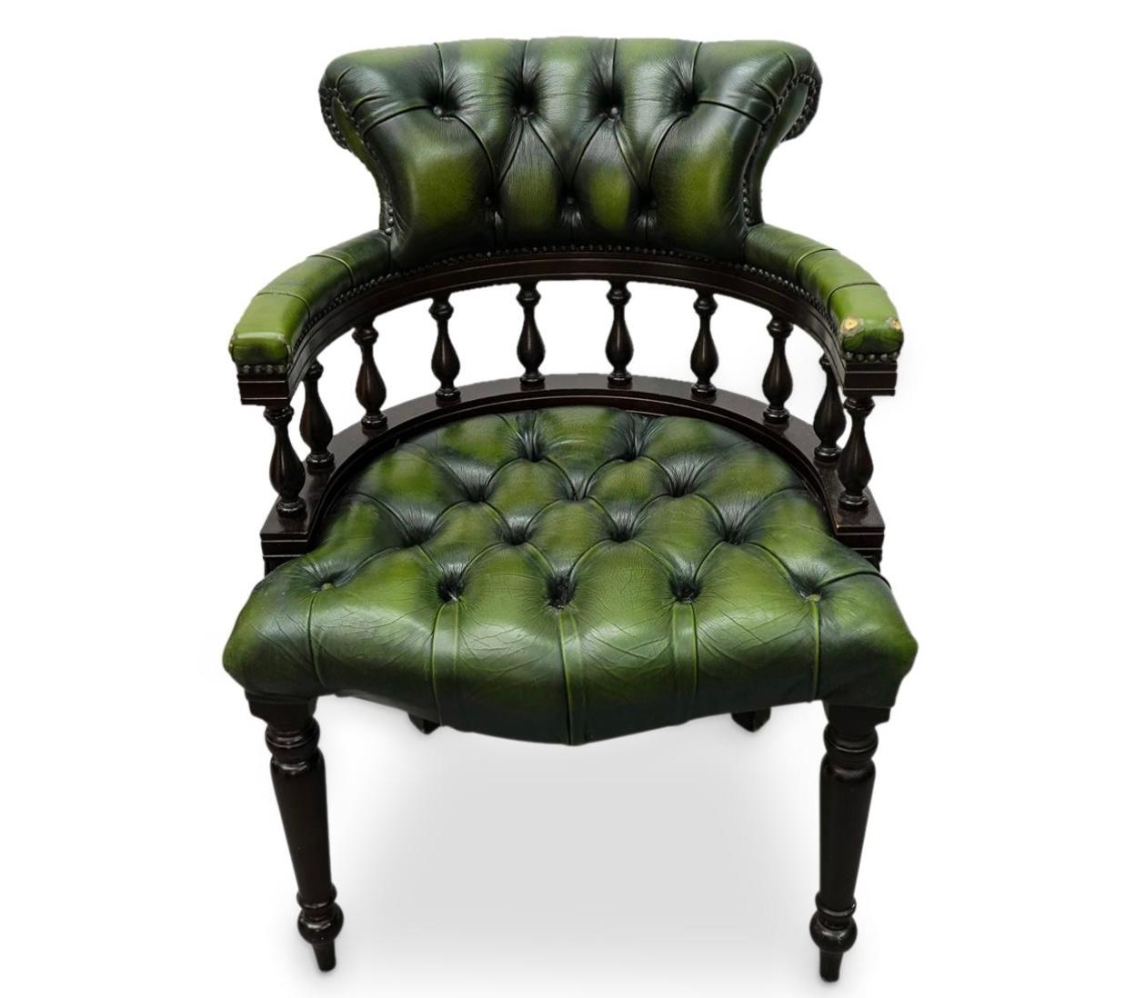 Handsome 19th century olive green leather Chesterfield Captain's Chair. Chair featured high quality deep buttoned tufted green leather and rich dark turned spindle wooden components. Leather has aged beautifully over time and has a nice patina. The