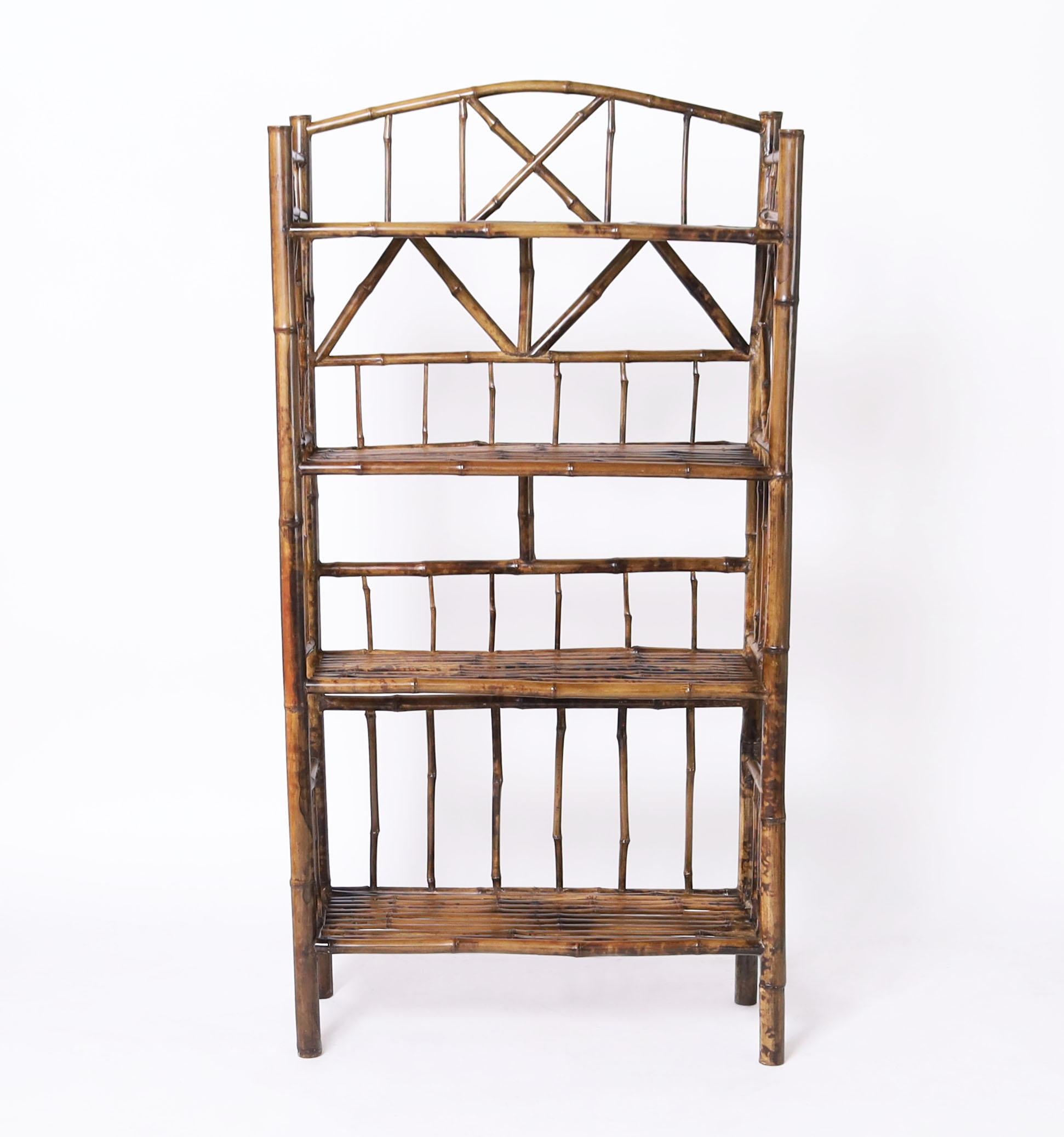 Standout 19th century English etagere crafted in bamboo with four shelves in a Chinese chippendale form. 