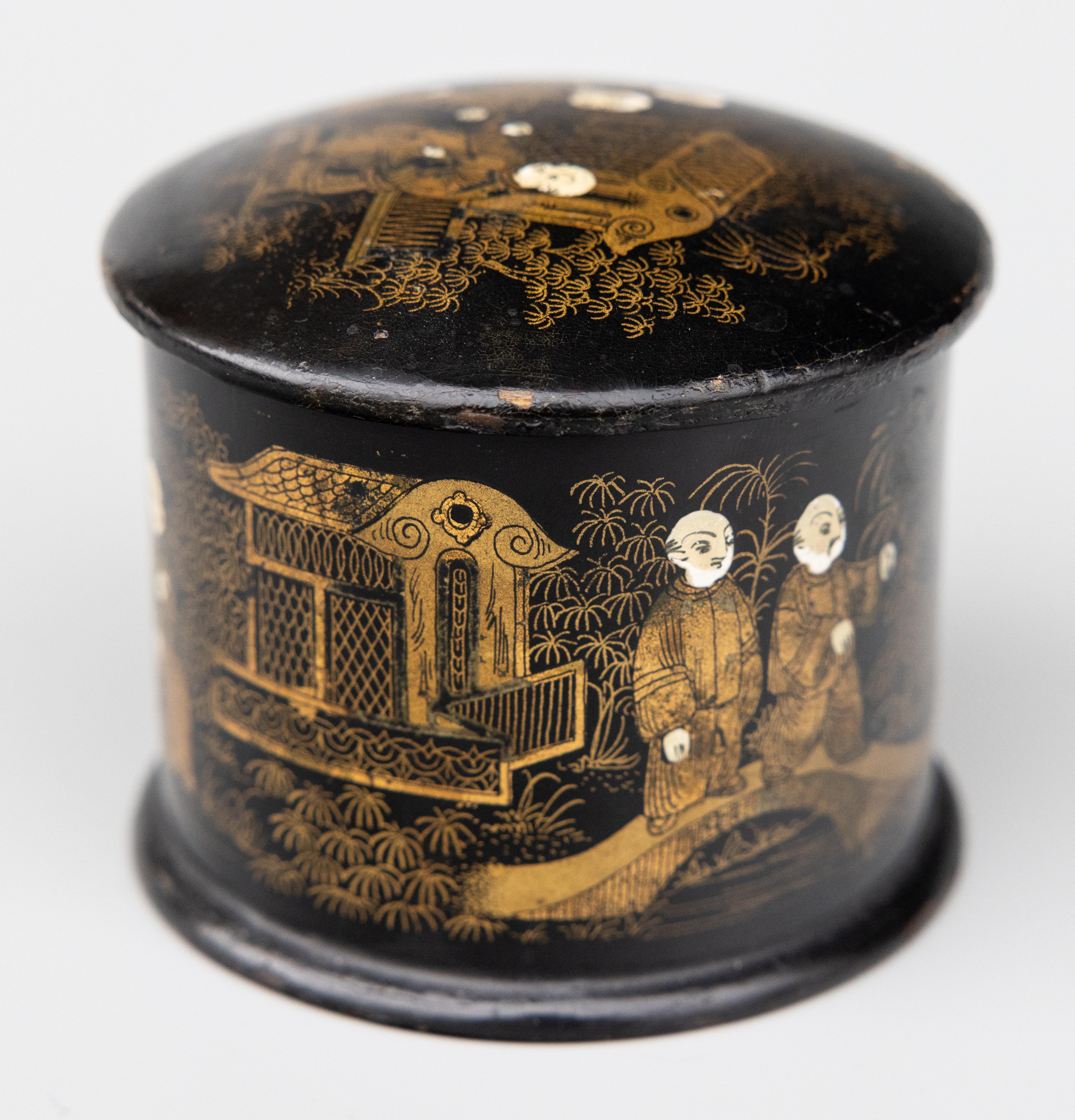 A superb antique English black ebonized japanned papier mache lidded dresser box or trinket box with an Asian chinoiserie design, circa 1880. This Fine box is handmade with hand painted monk figures, Chinese garden scenes, and pagodas on a black