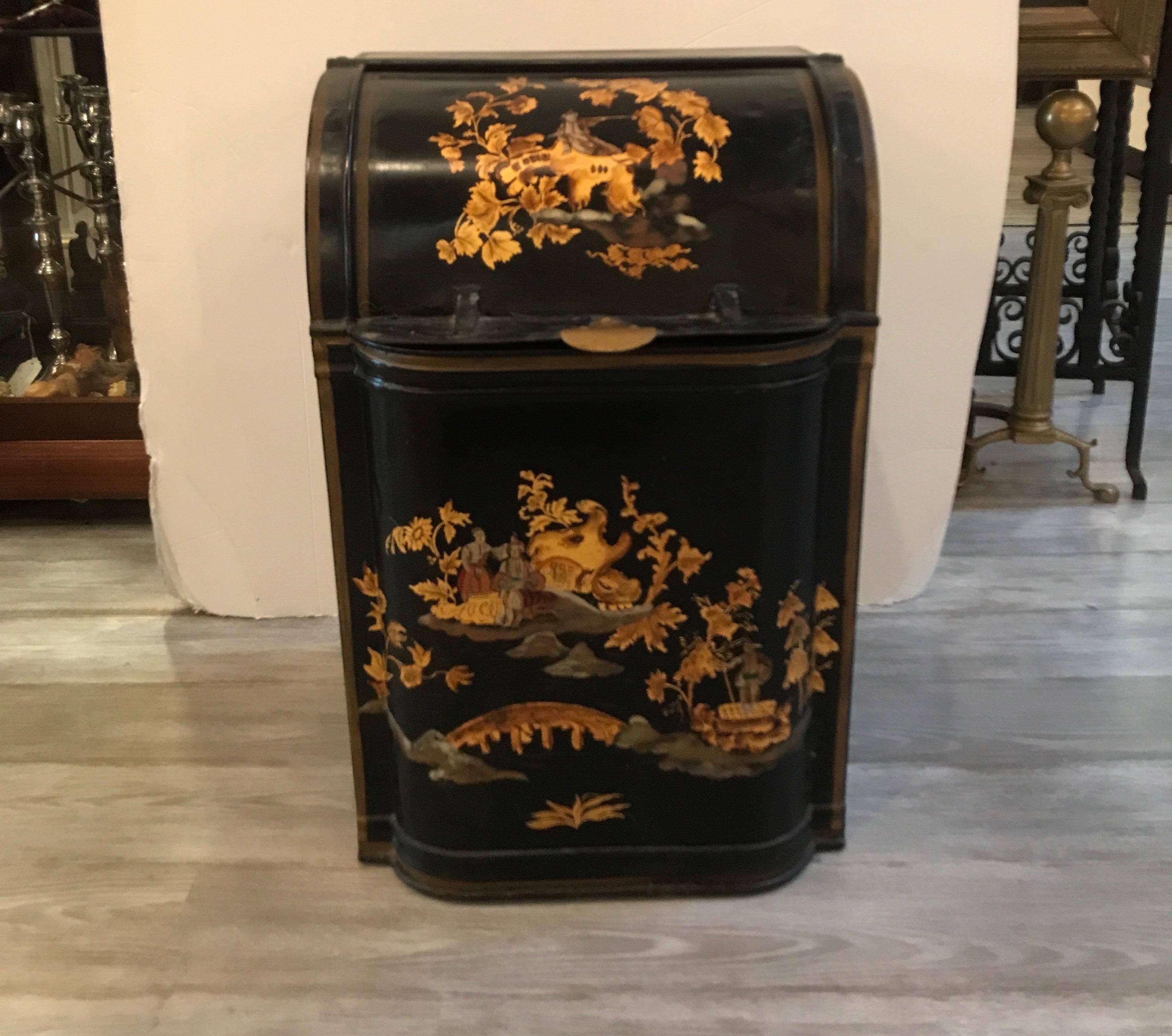 A tin and brass hand painted tea bin. This tea bin would be a nice tinder box or storage for any home. The black base color with hand painted Asian inspired decoration, circa 1870s. The painting may have been done later. The bottom has been replaced.