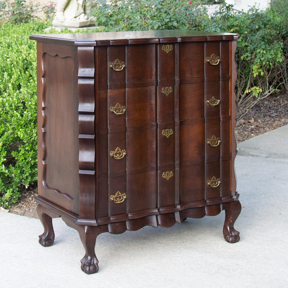 Antique English Chippendale chest of drawers is a handsome expression of the style, with undulating cornerposts and drawer facades accentuated by finely cast brass pulls and key guards to accentuate the facade comprised of exotic imported