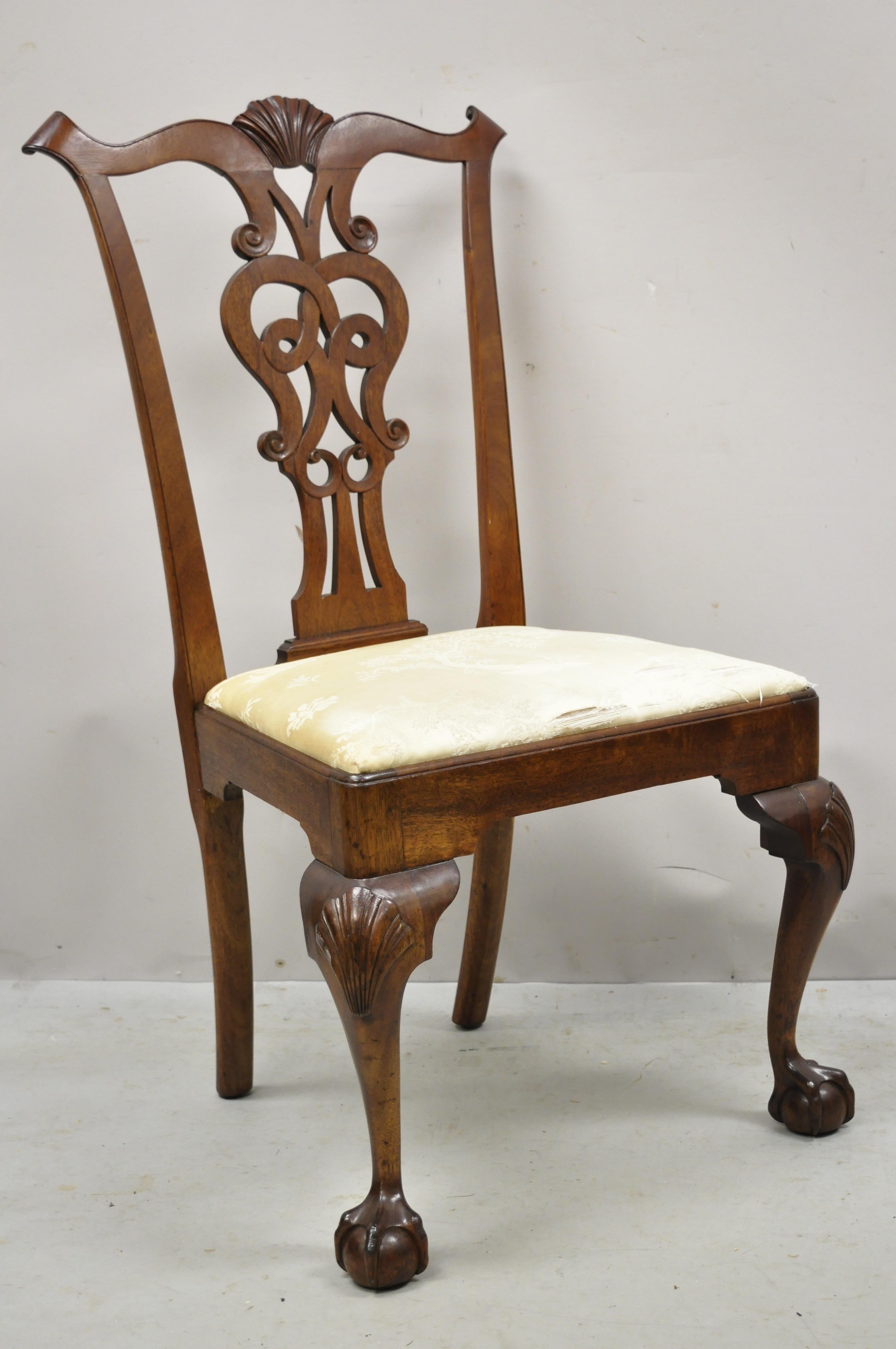 Antique English Chippendale mahogany carved ball and claw shell carved dining side chair. Item features shell carved knees, solid wood construction, beautiful wood grain, nicely carved details, carved ball and claw feet. Circa early 1900s.