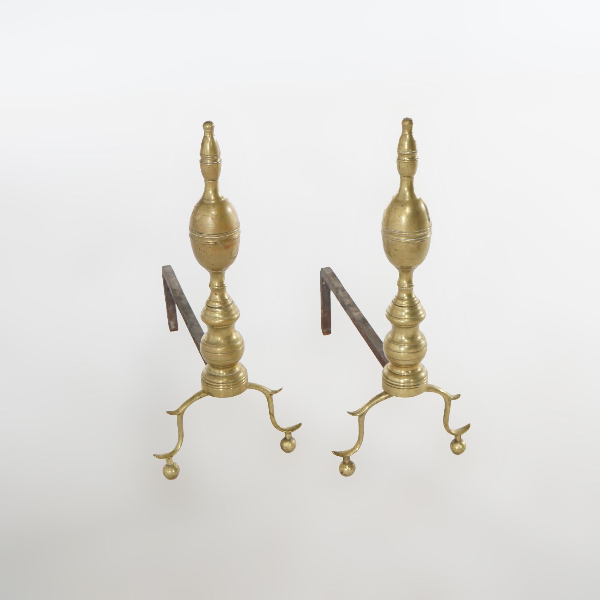 An antique set of fireplace andirons offers brass construction in balustrade form raised on scroll form cabriole legs with ball feet, c1900
 
Measure - 20