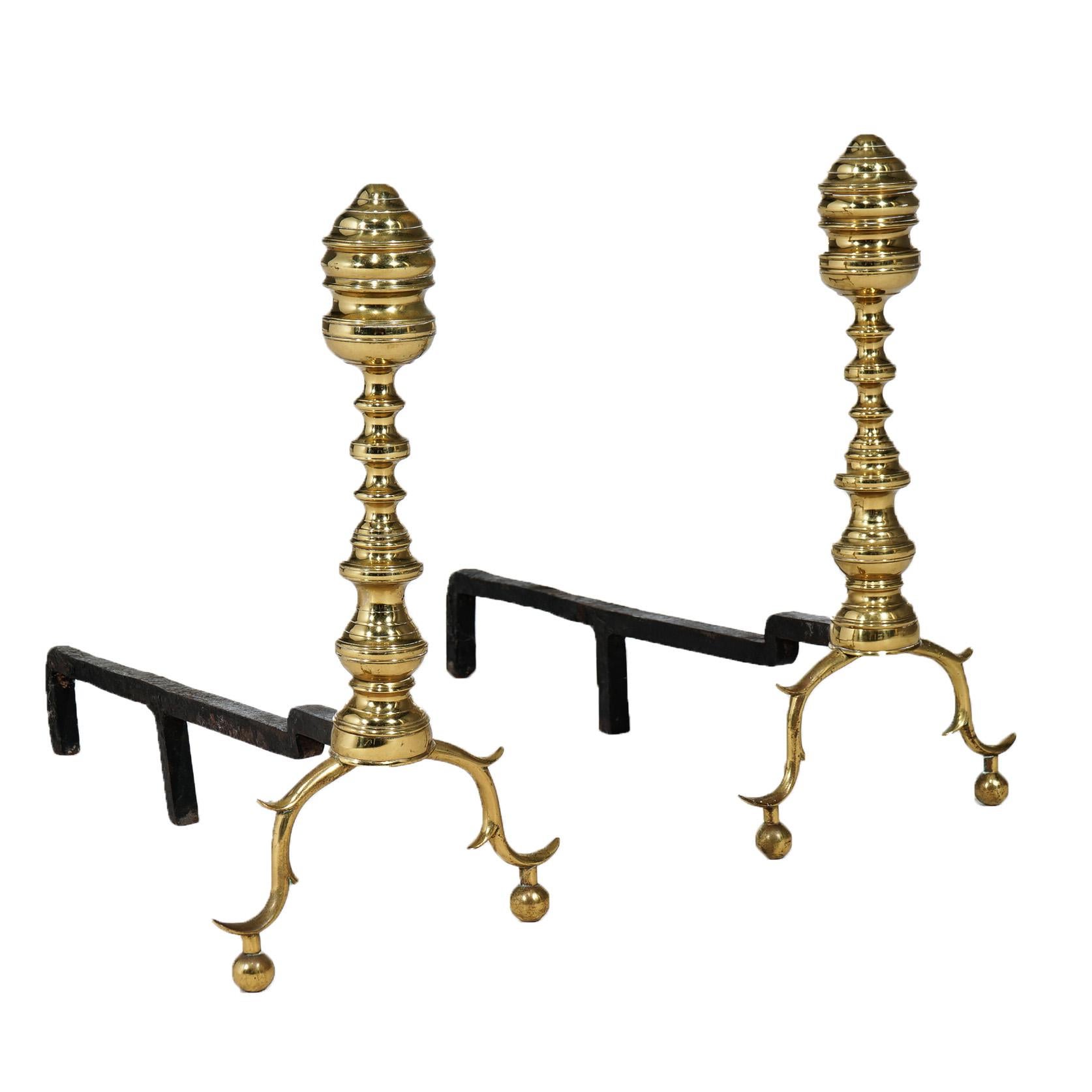 An antique set of English Chippendale style fireplace andirons offers brass construction in balustrade form having beehive finials and raised on scroll form legs with ball feet, 20th century

Measure - 19
