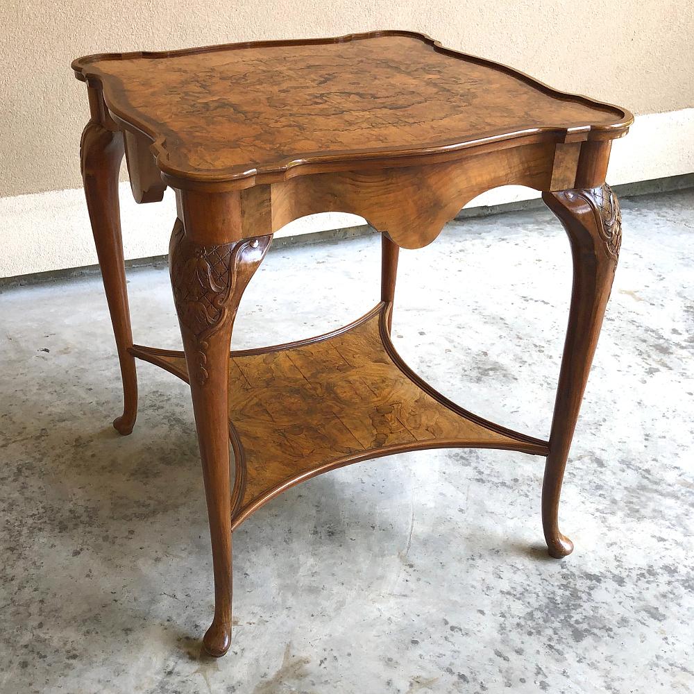 Antique English Chippendale tea table with tray was fashioned from imported walnut, and features the traditional cabriole legs with broad shoulders, a webbed shelf below, and a glass tray top that adds a level of sophistication and