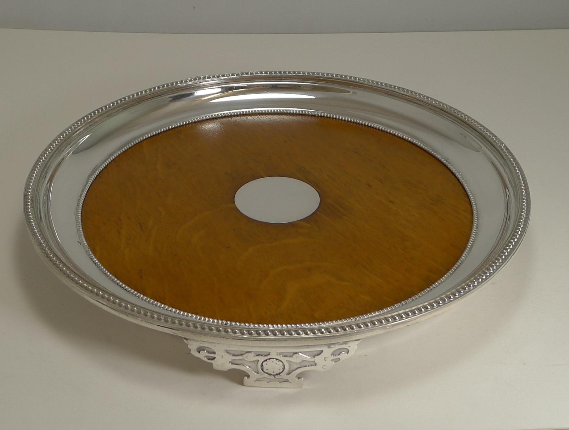 A rare circular oak and silver plated tray, unusual, you just don't come across circular examples and early examples like this.

The underside is lucky enough to have an English design registration lozenge which we can date to 17th October