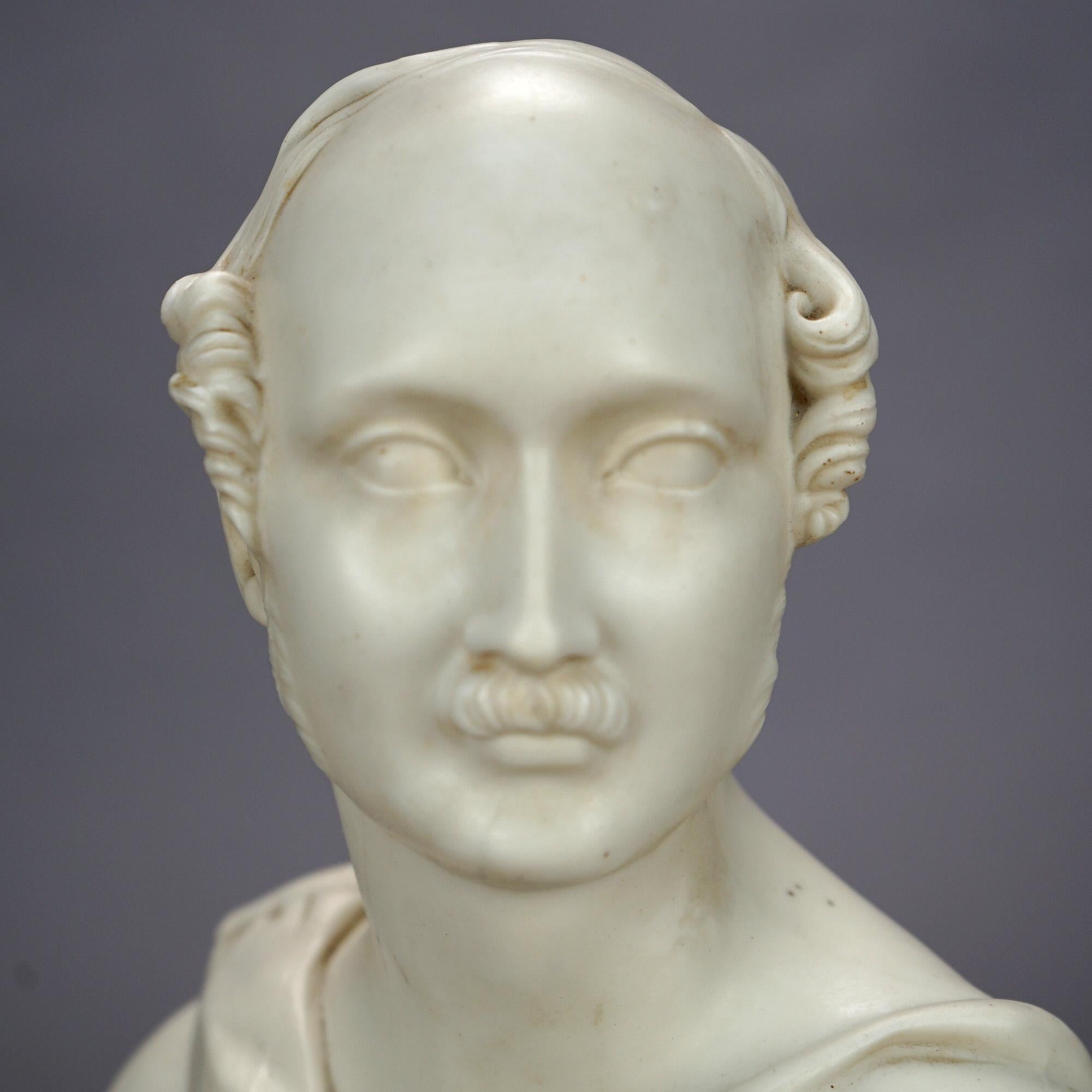 An antique bust marked B. J. Jones, Worcester offers parian porcelain construction and depicts a man with a distinguishing honor medal, raised on circular plinth, maker mark on base as photographed, 19th century.

Measures: 12.75'' H x 8.5'' W x