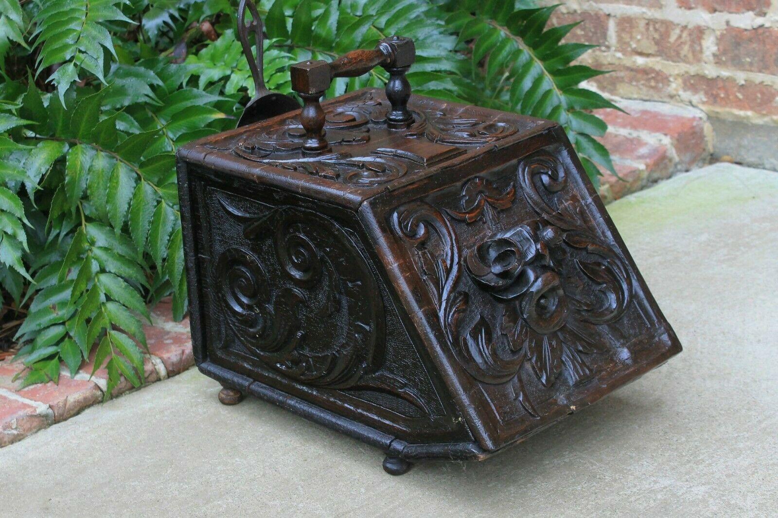 Antique English oak hand carved oak lift top coal hod Scuttle~~c. 1880s-1890s

Ornately carved foliage, berries and scroll work~~carved on all sides

Slant top with carved handle, original tin liner and brass shovel~~traditional old world