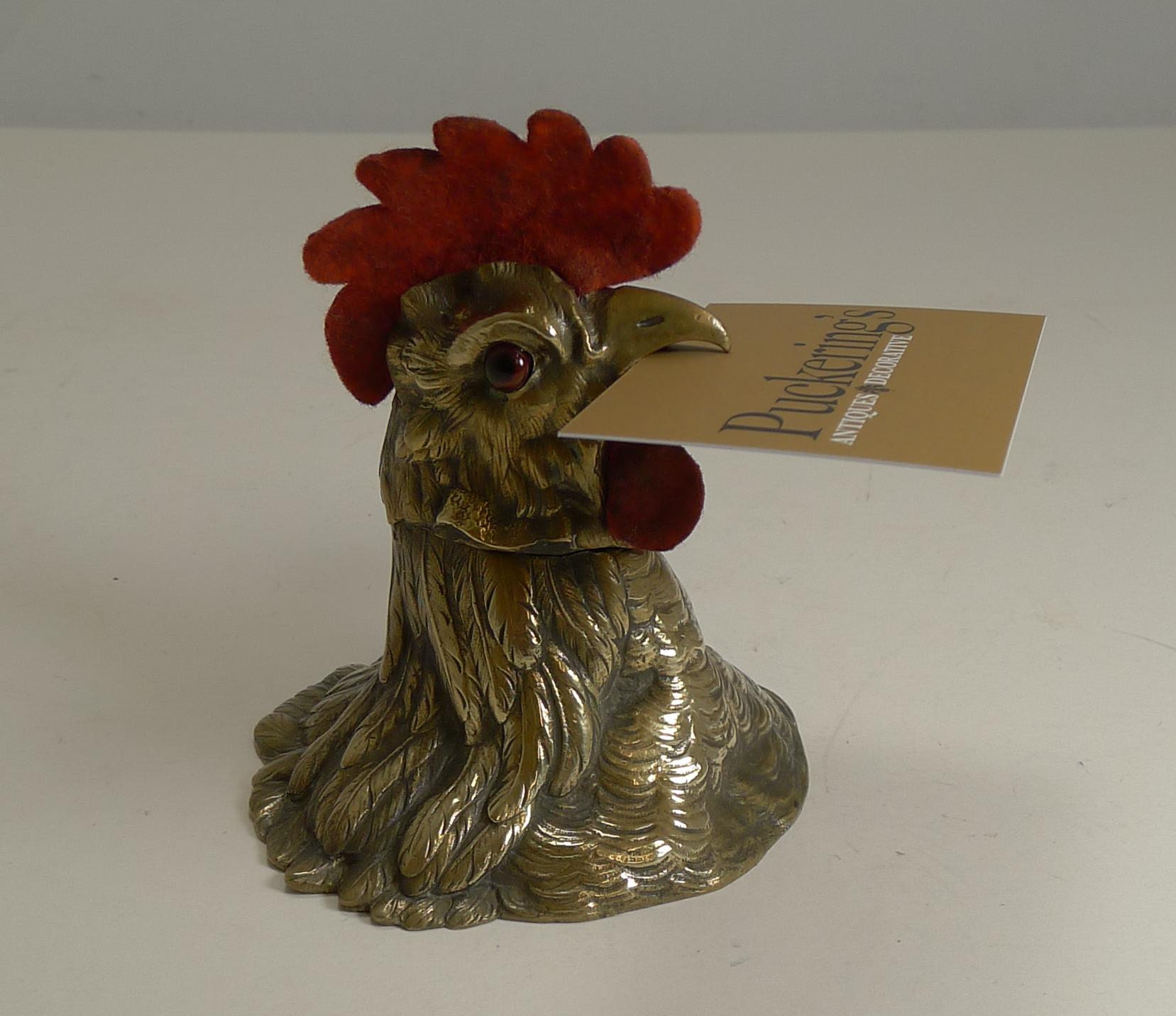 This is a fabulous and rare find, I haven't seen this one ever before.

Cast from English brass and dating to the late Victorian era, the Cockerel is beautifully executed with great detail and retaining his two glass eyes. The red felt Comb to the
