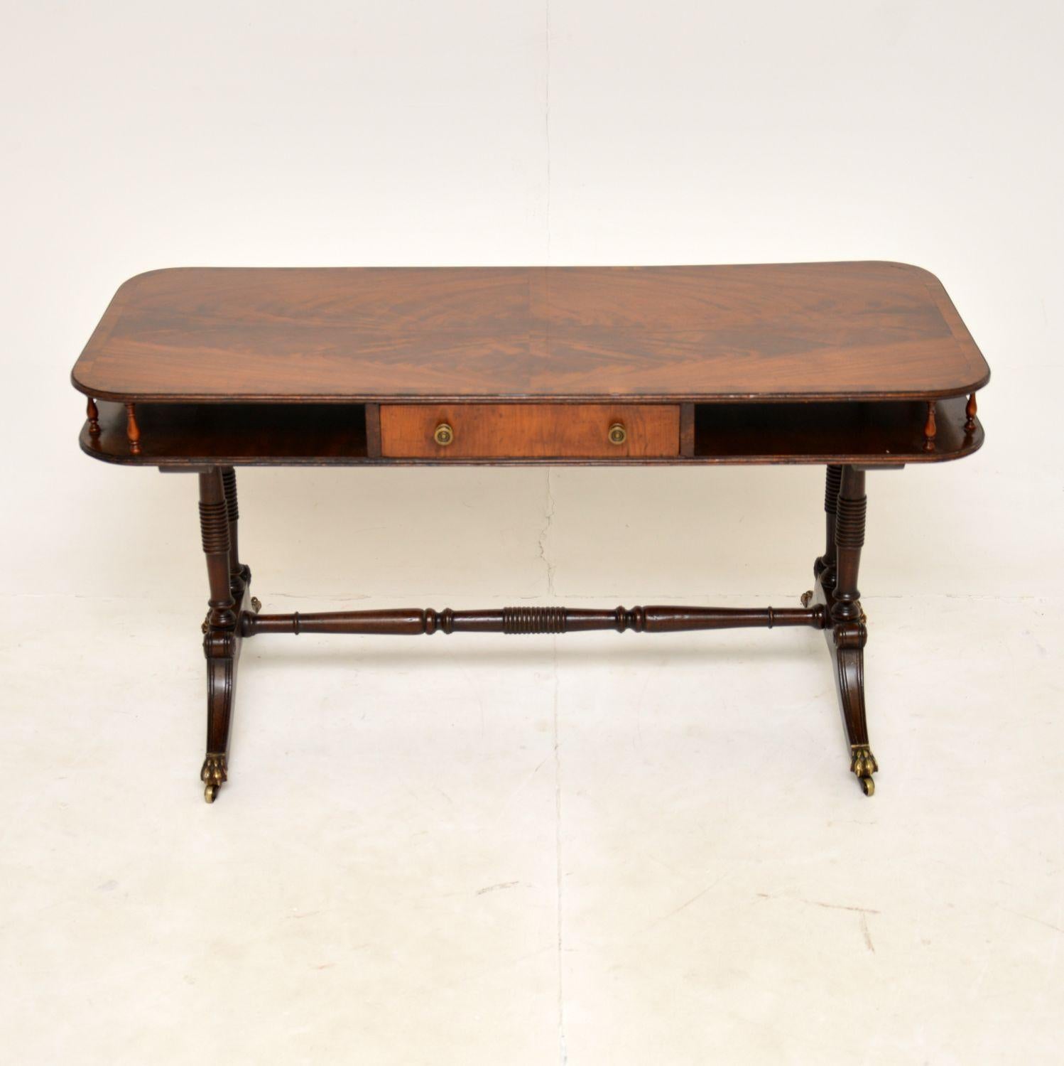 An impressive and extremely well made antique coffee table. This is in the Regency style, it dates from the 1920-30’s.

The quality is fantastic and this is a very useful size. There is a central drawer and an open lower tier on either side of the