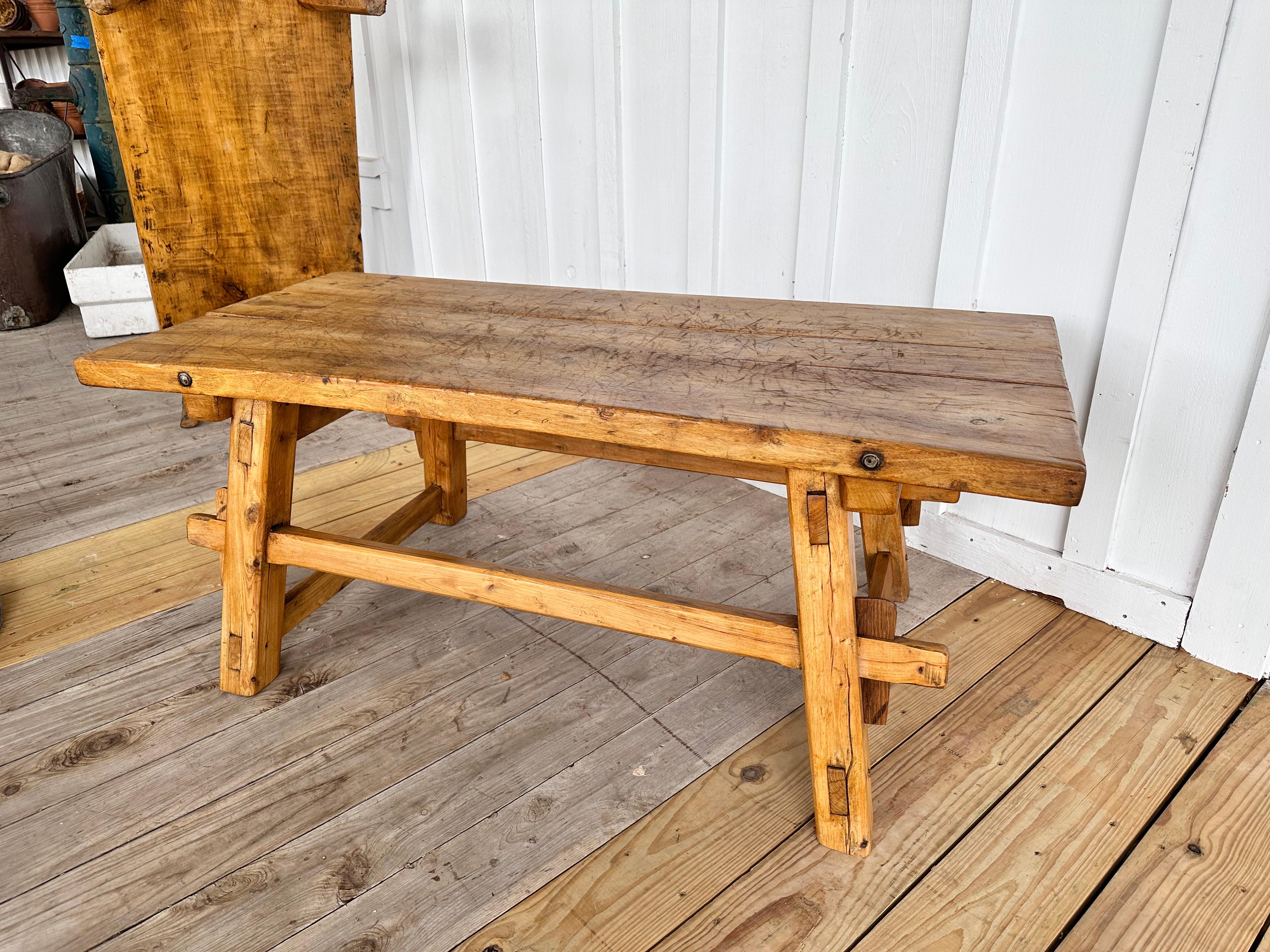 This 19th century coffee table is simple yet beautiful! This piece was orginial used as a butcher's chopping table and has been since cut down to coffee table size. The years of use have created great patina as well as unique detail on the top. The