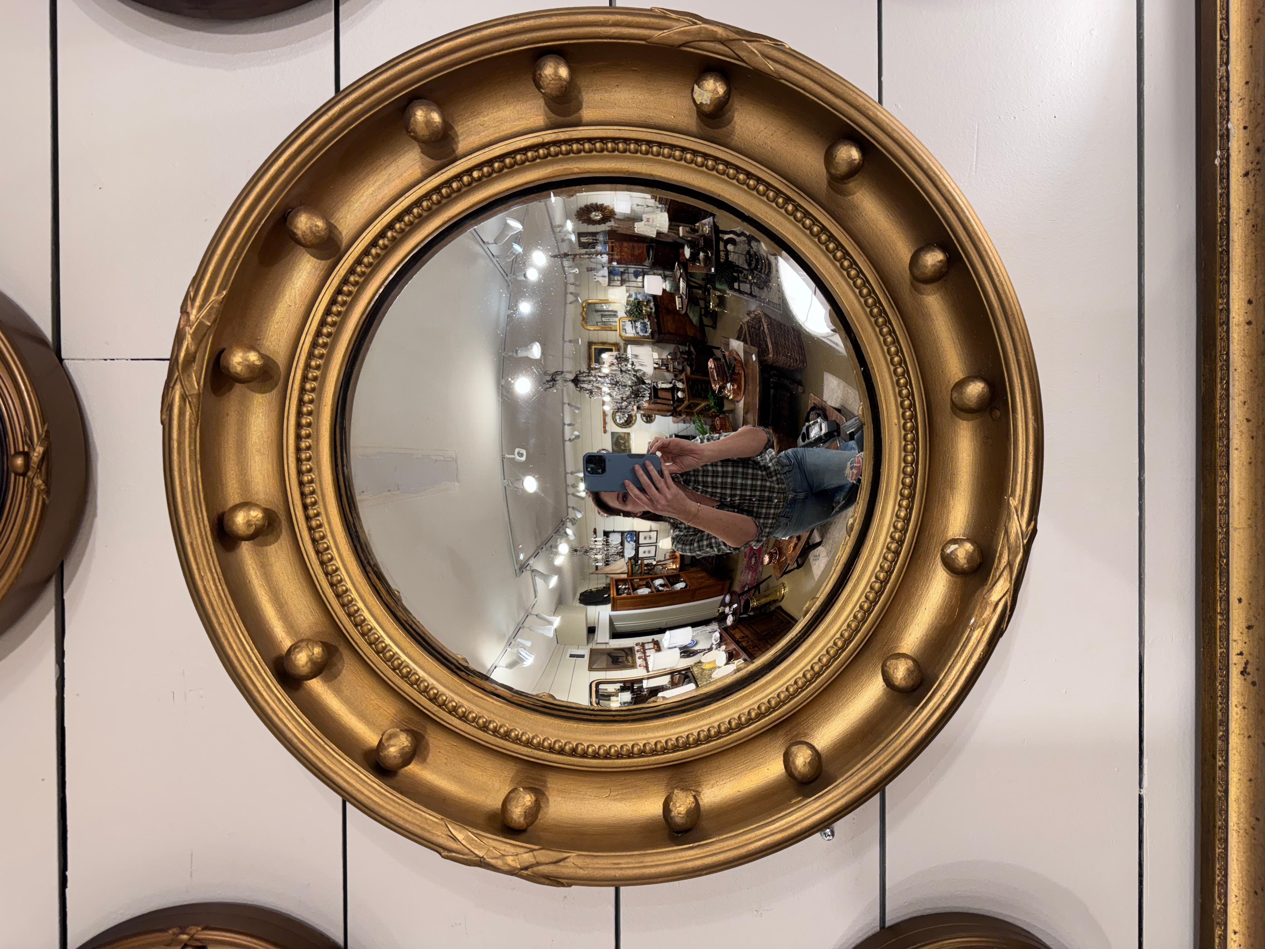 This all original antique English Regency mirror would be right at home in the interior design styles of today. Fitted with hand-carved spherical vintage hold knobs in vintage gold giltwood frame, this mirror would add style to any home decor and
