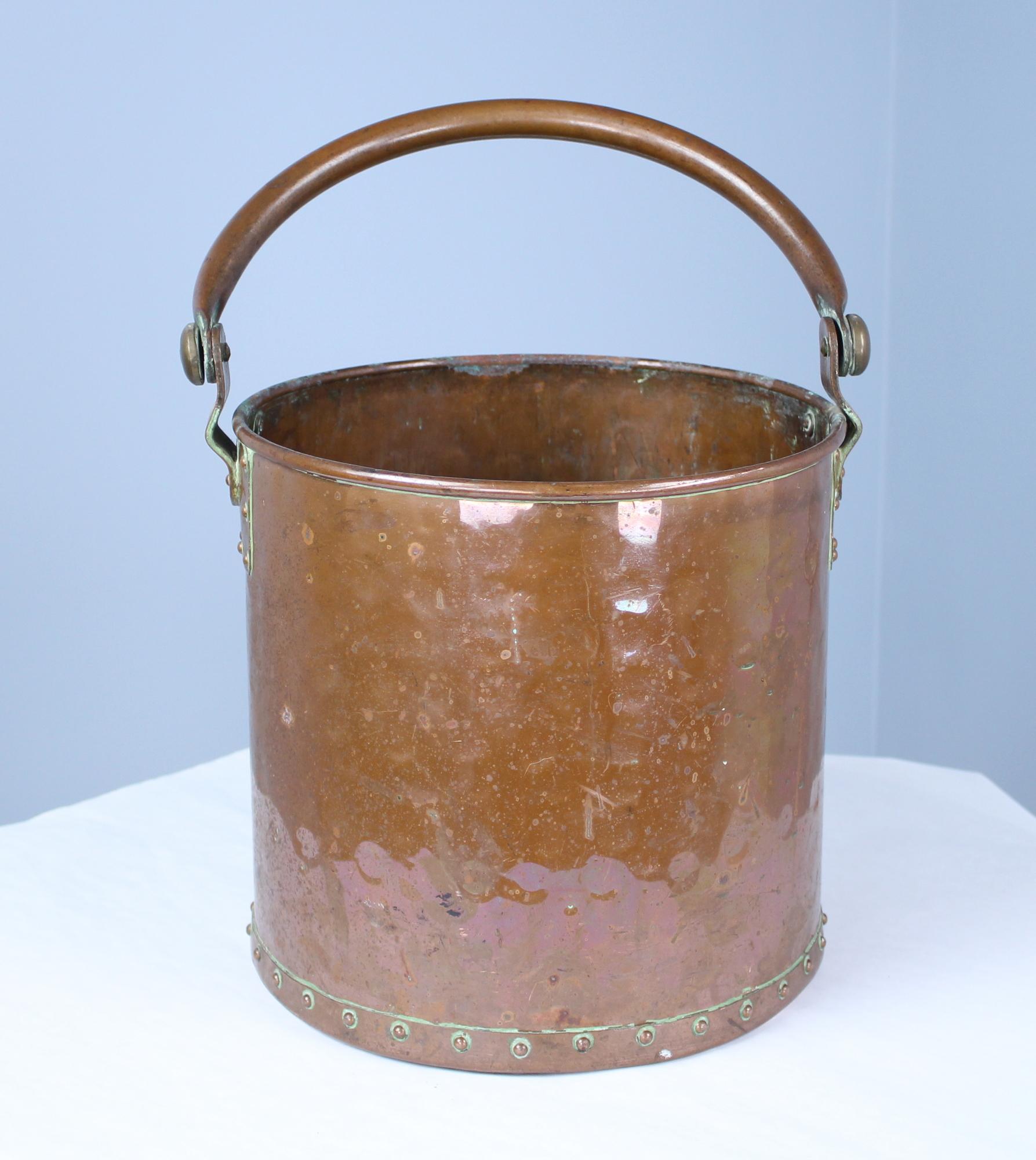 A wonderfully thick and heavy copper log bin or pail from late 19th century, England. We love the studs around the bottom! Height measurement is for the bin without the handle.