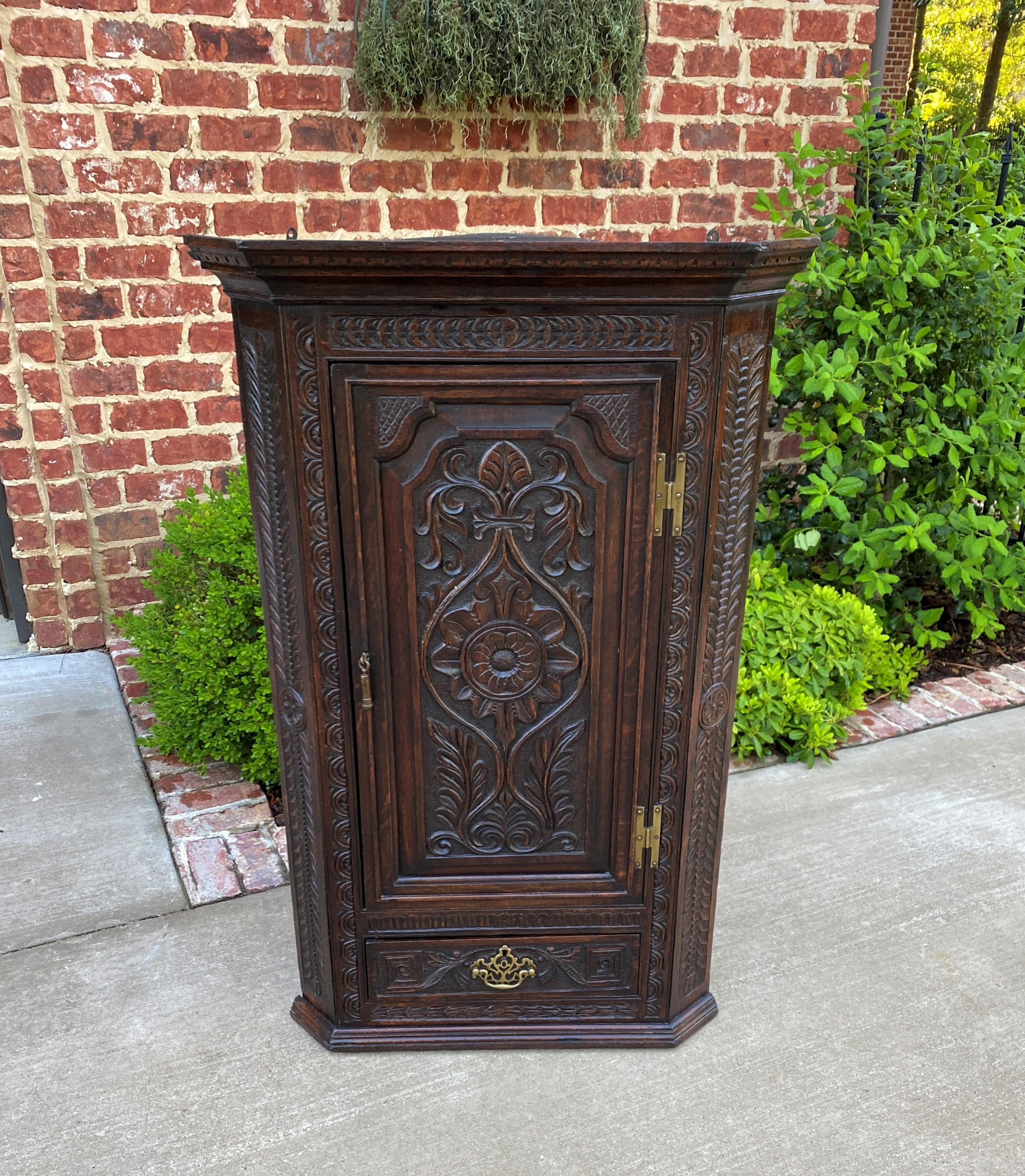 Beautifully carved antique English dark oak hanging wall or freestanding corner cabinet, medicine or spice cabinet with interior shelves~~c. Mid to Late 19th Century

Full of classic English charm~~beautifully carved dark oak wall or freestanding