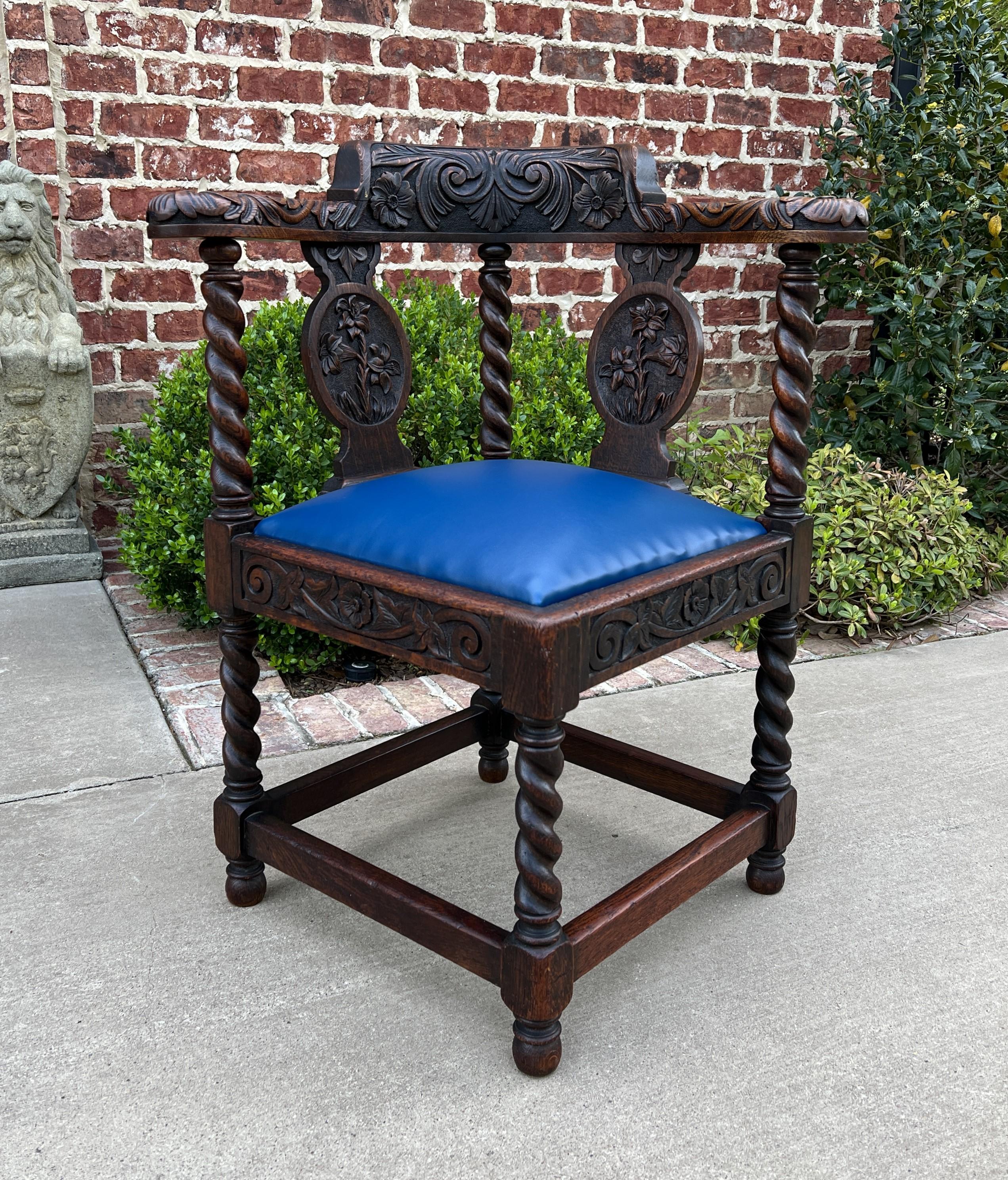 STUNNING Antique English Renaissance revival oak barley twist corner chair~~circa 1920s

Classic English charm and style~~notice the DETAIL in the highly carved back, arms, skirt, and barley twist legs

New blue leather upholstered seat with new