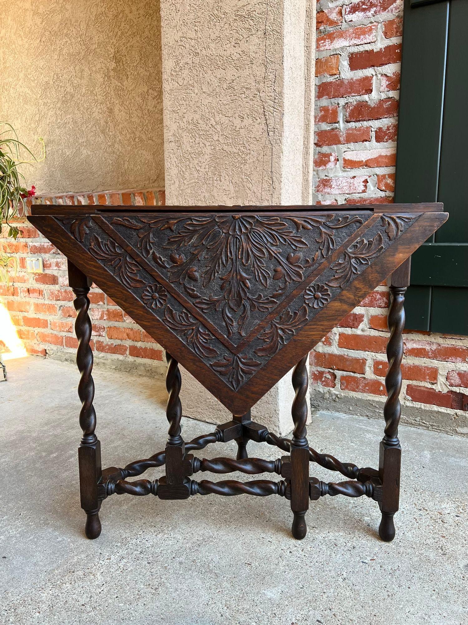 Antique English Corner Table Handkerchief Drop Leaf Barley Twist Carved Oak.

 Direct from England, a highly sought-after antique “handkerchief” table or “corner table” as it can easily be tucked in a corner with the leaf down. With leaf up, it’s