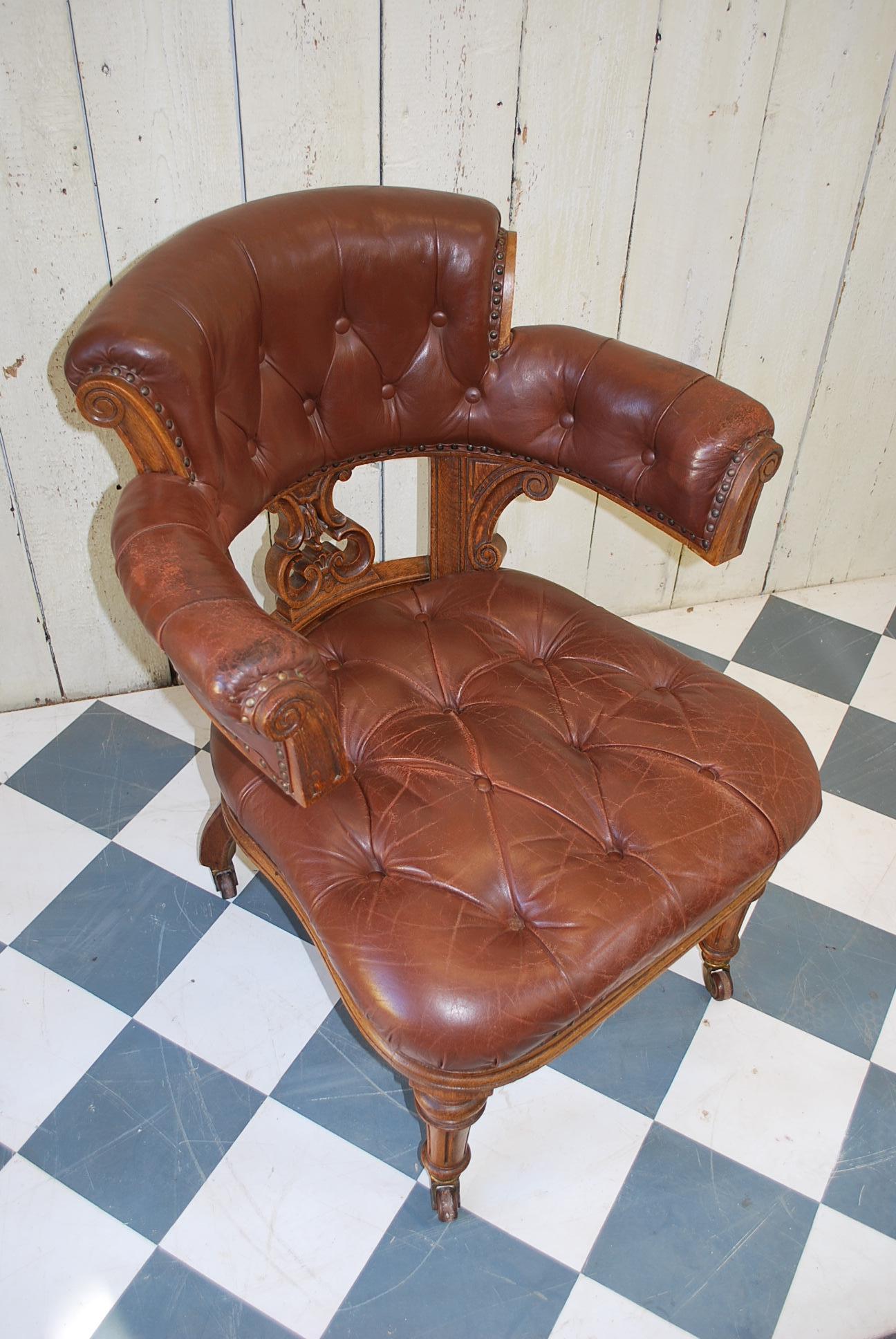 An important oversized oak desk chair with nicely worn brown leather deep button upholstery, probably by Holland and Son or a similar maker. One of the best examples I have had the pleasure of owning. Excellent condition generally for age. Just that