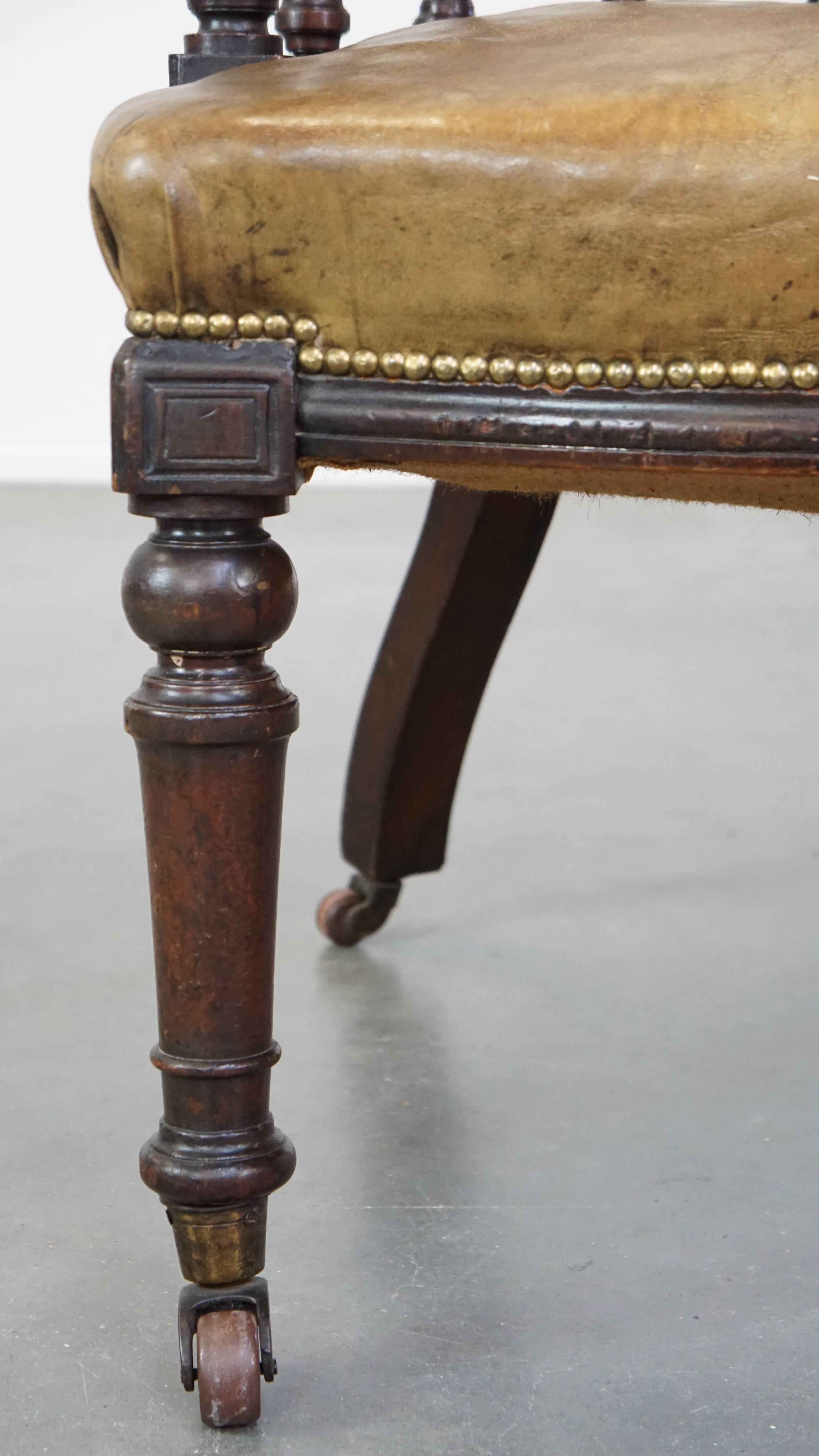 Antique English cowhide leather desk chair combined with wood on original wheels For Sale 3