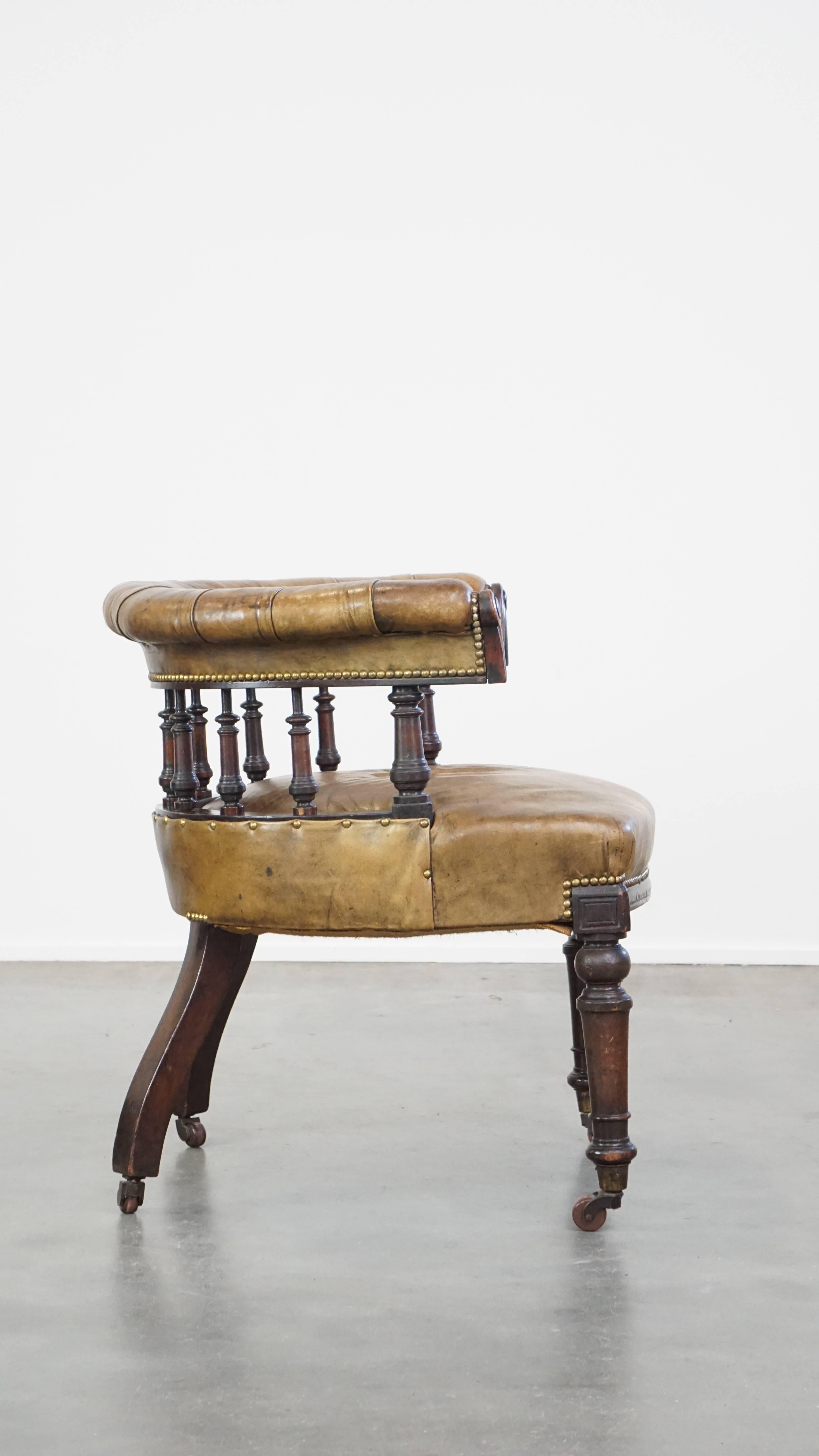 Chesterfield Antique English cowhide leather desk chair combined with wood on original wheels For Sale