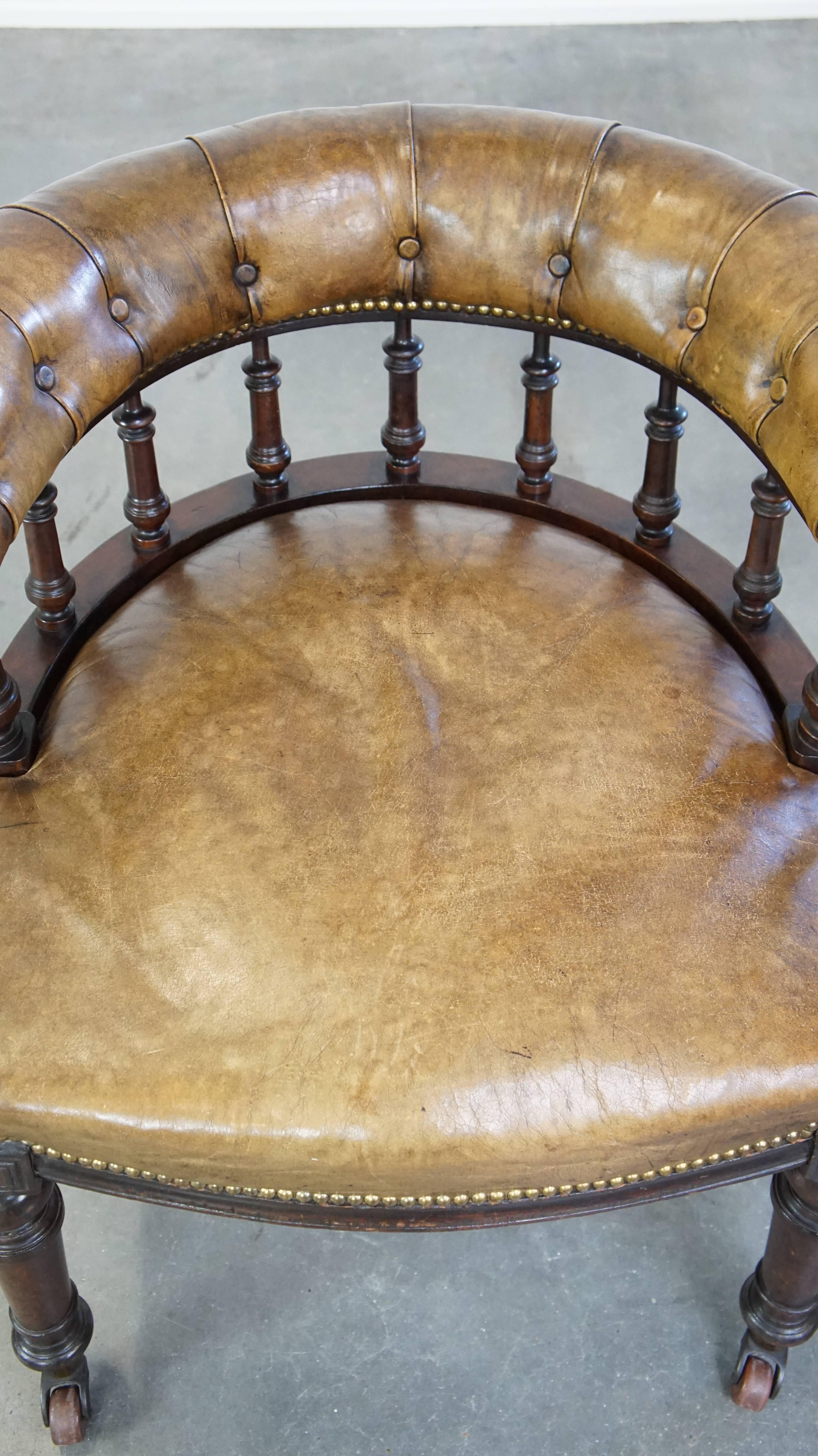 19th Century Antique English cowhide leather desk chair combined with wood on original wheels For Sale