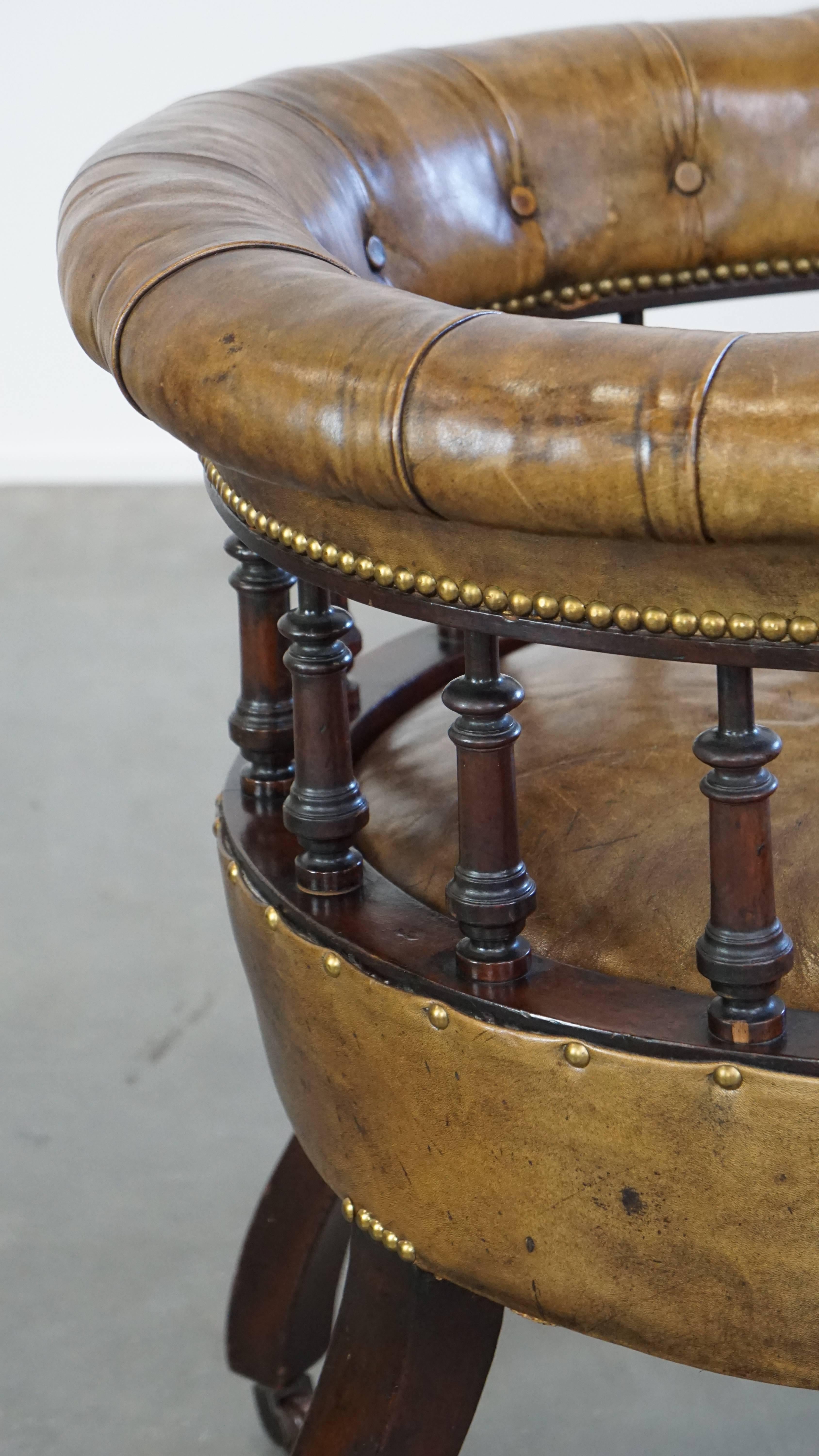 Antique English cowhide leather desk chair combined with wood on original wheels For Sale 1