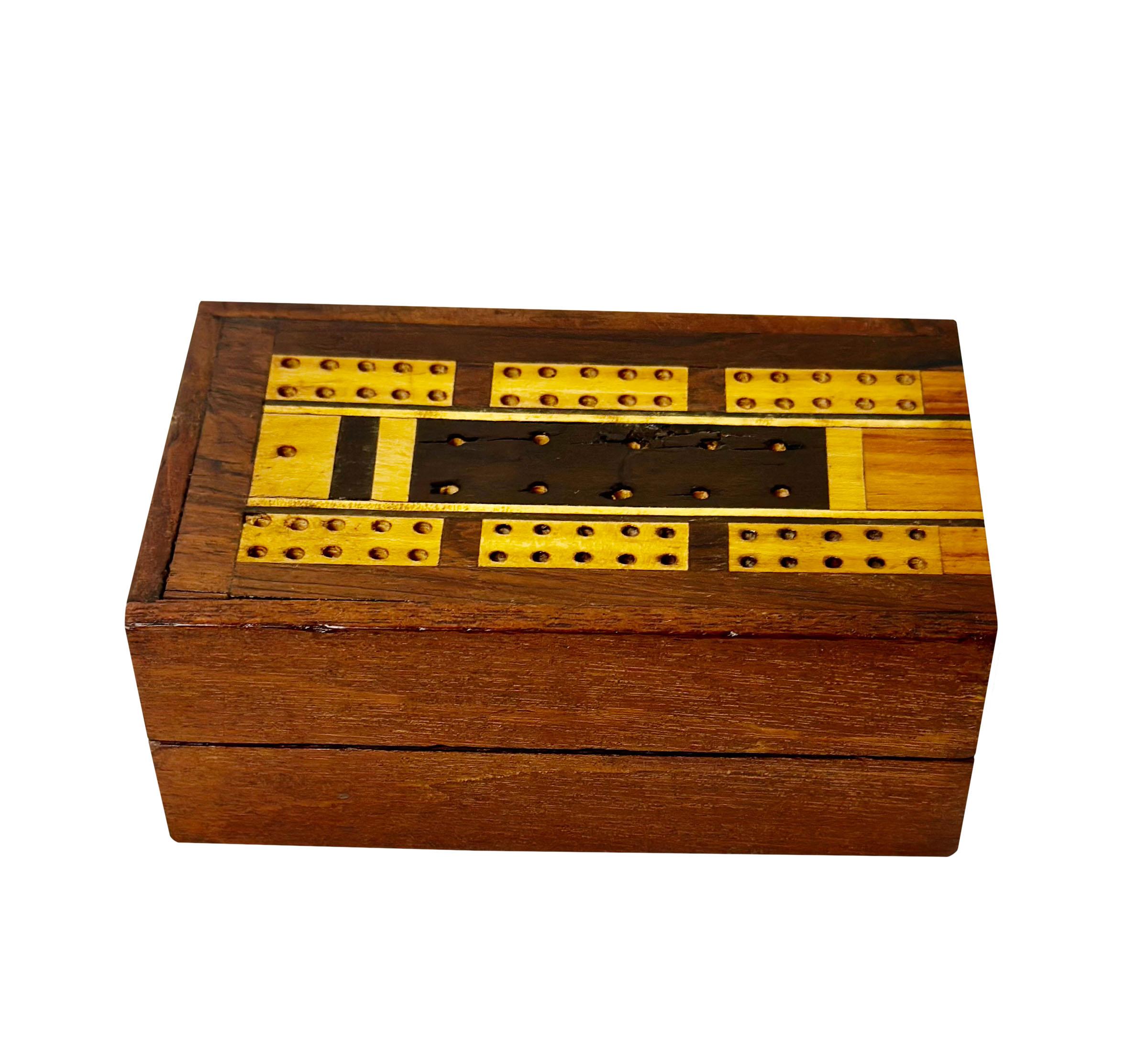 This is English late 19th century or could be a little earlier and in very nice condition. The box is beautifully inlaid has several kinds of wood, including Rosewood Mahogany and Pearwood. Includes two decks of playing cards and also has little
