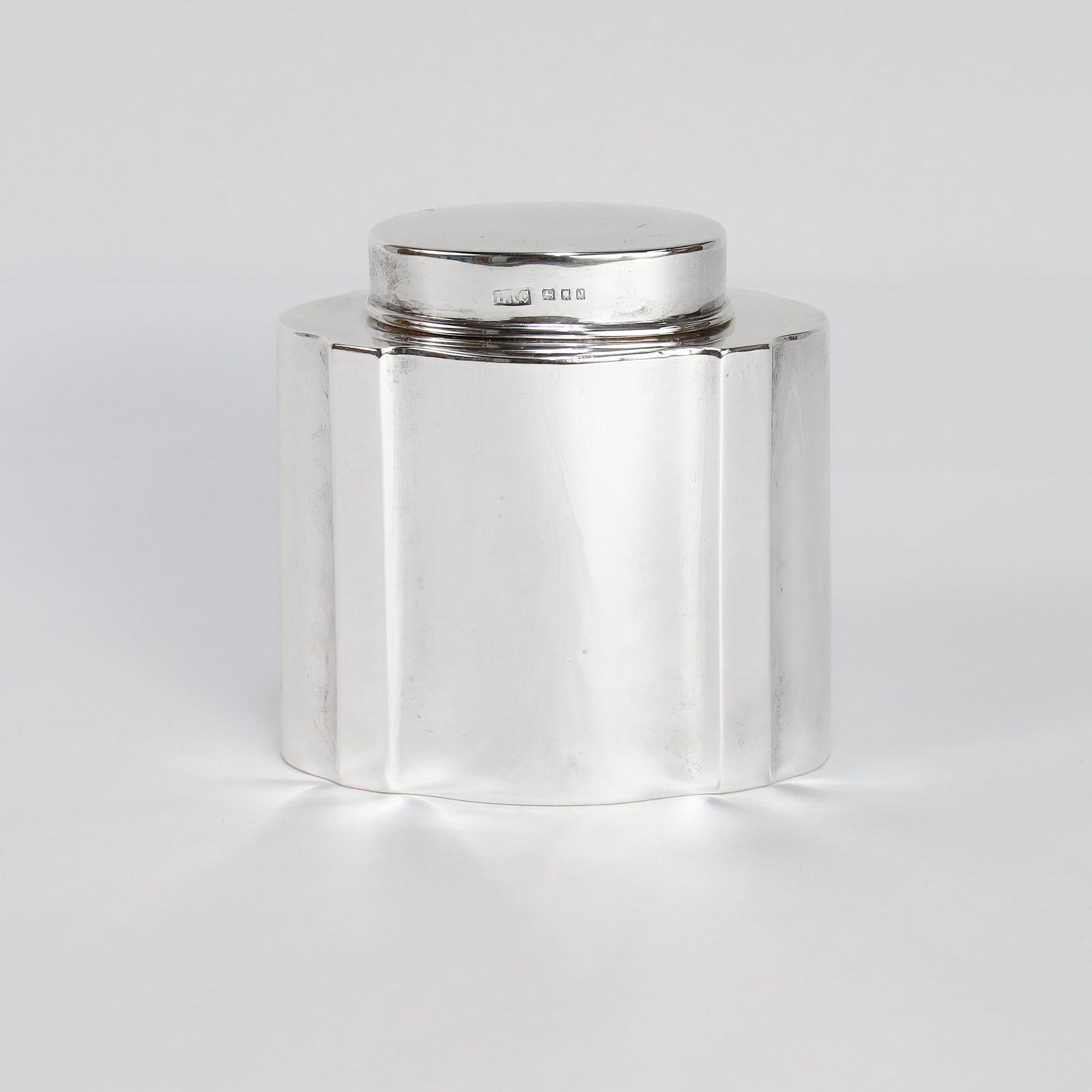 A fine antique English tea caddy.

In sterling silver.

By Crichton Bros.

With shaped sides having 4 convex ridges.

Marked to the lid with English hallmarks and to the base with additional marks.

Simply a wonderful antique English silver tea