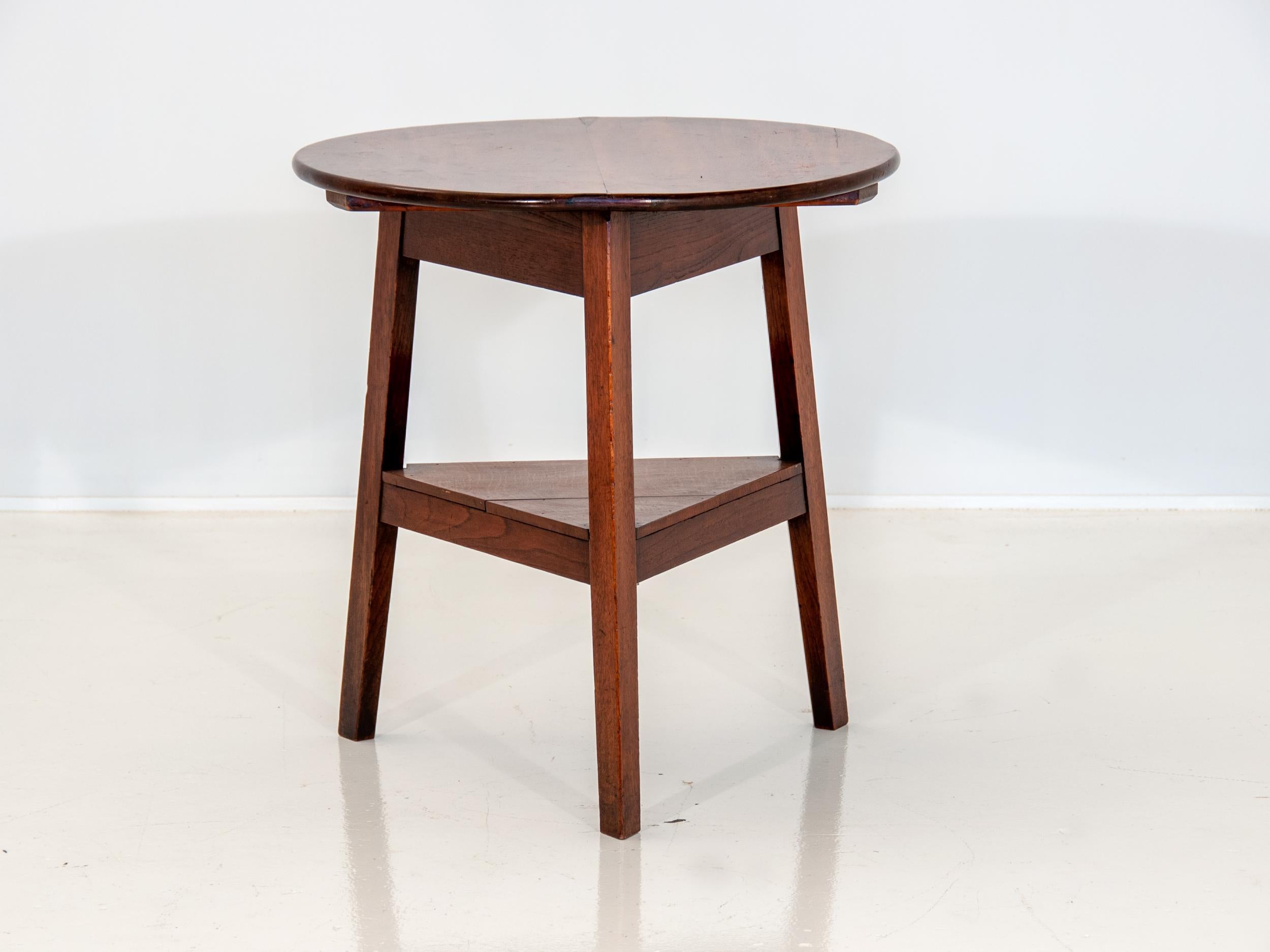 19th century antique cricket table. Originally used as a pub table, this table has a mahogany top and an ash base. A beautiful table with a variety of uses. Measure: Shelf height is 9.5