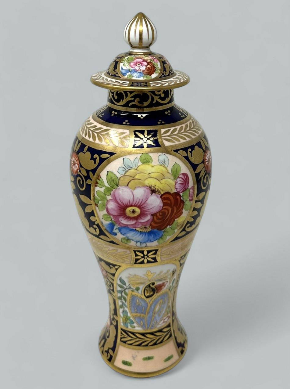 Superb Crown Staffordshire Hand Painted Ovoid Form lavish gilt lidded English Porcelain covered Vase or Centerpiece. Late Nineteenth, early Twentieth Century. 

The central reserve exquisitely hand decorated depicting Summer Flowers within a superb,