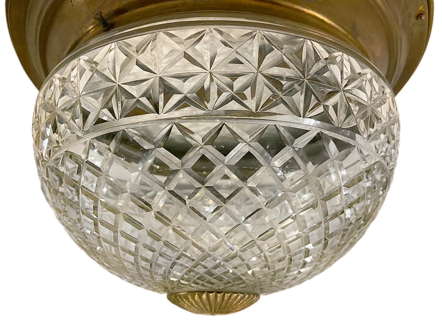 A circa 1920s English cut crystal flush mounted light fixture with interior lights.

Measurements:
Diameter 14