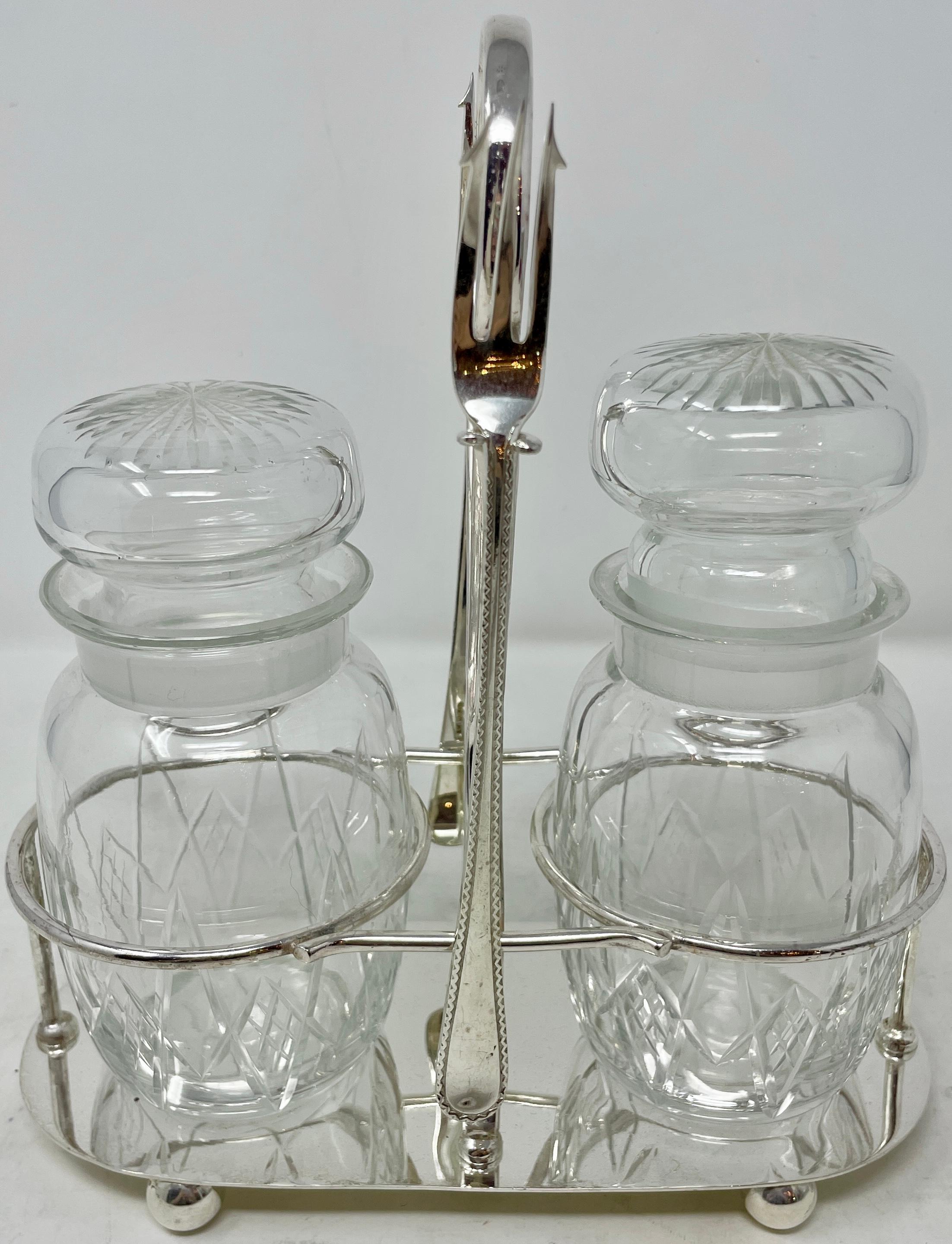 Antique English silver-plated double pickle castor with crystal jar & forks, circa 1900-1910.
Includes handled stand, 2 jars with stoppers and 2 pickle forks.