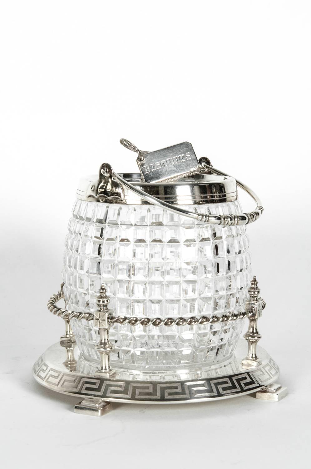 Antique English cut crystal barrel biscuit with detachable silver plate holding basket tray and cover. The piece measures 9 inches high to the handle and about 6 inches diameter. The silver plate holding basket tray is 8 diameter x 3 inches high.