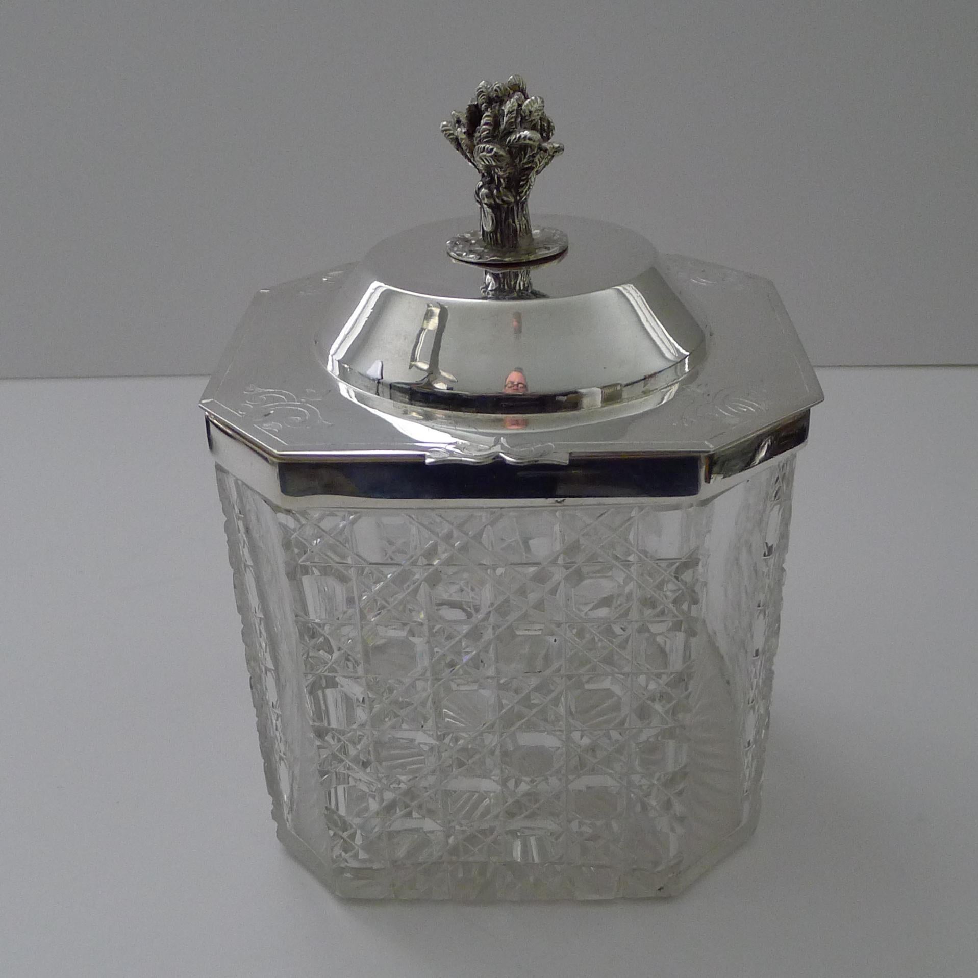 A hefty piece of crystal was used to make this fabulous box, deeply and beautifully cut on four sides with the ever-popular hobnail cut with clear cantered corners; the underside is star cut.

The collar and hinged lid is made from silver plate, the