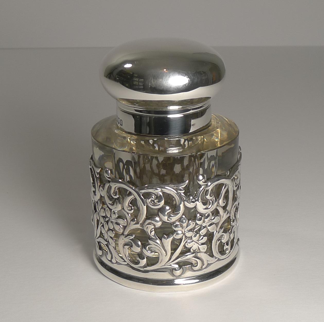 A beautiful late Victorian inkwell made from a hefty piece of English crystal or circular form with the underside intricately handcut in the ever-popular hobnail design.

The body of the glass is cased in a pierced or reticulated sterling silver