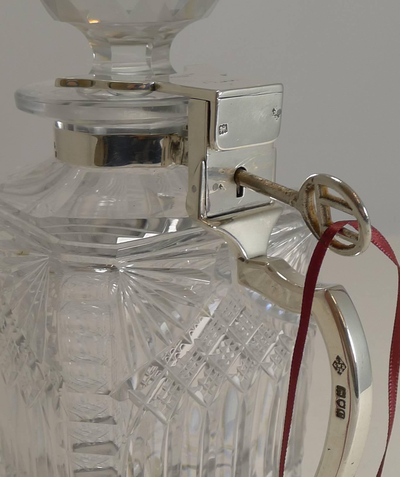 A scarce find, this Victorian Betjemann's Patent single locking decanter or tantalus is made from cut crystal and trimmed in solid sterling silver fittings.

The whisky decanter is beautifully cut and in undamaged condition. The fittings are fully