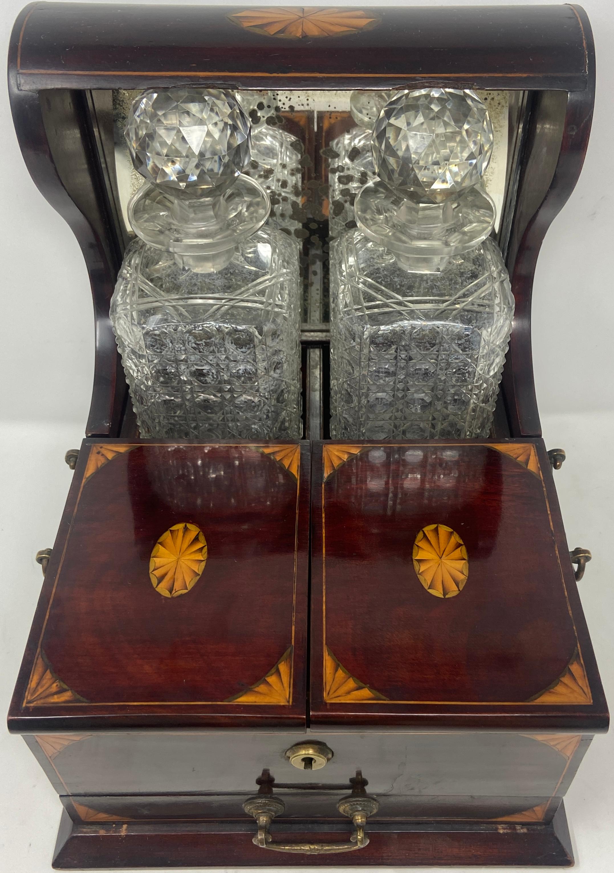 Antique English cut crystal two-bottle tantalus and mahogany games box, circa 1890.